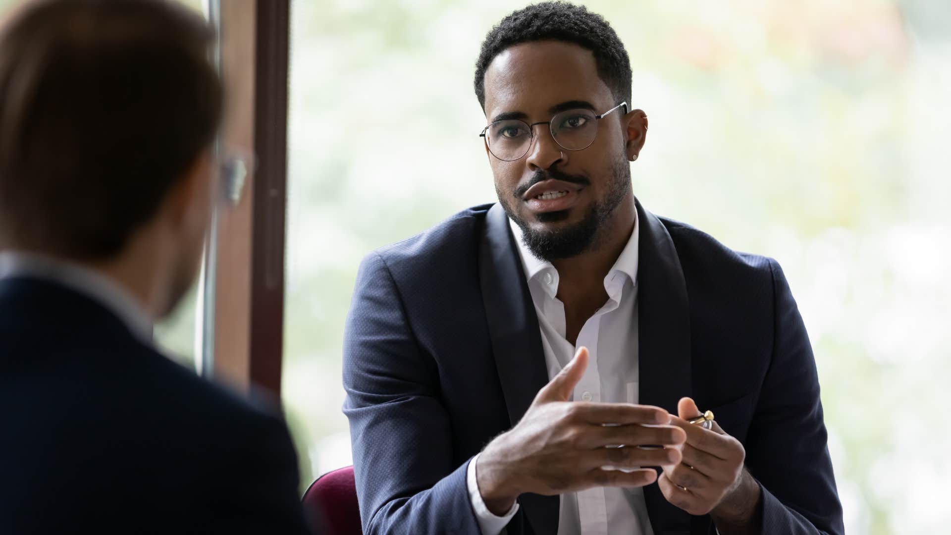 man who values effectiveness at work speaking to boss about prioritizing