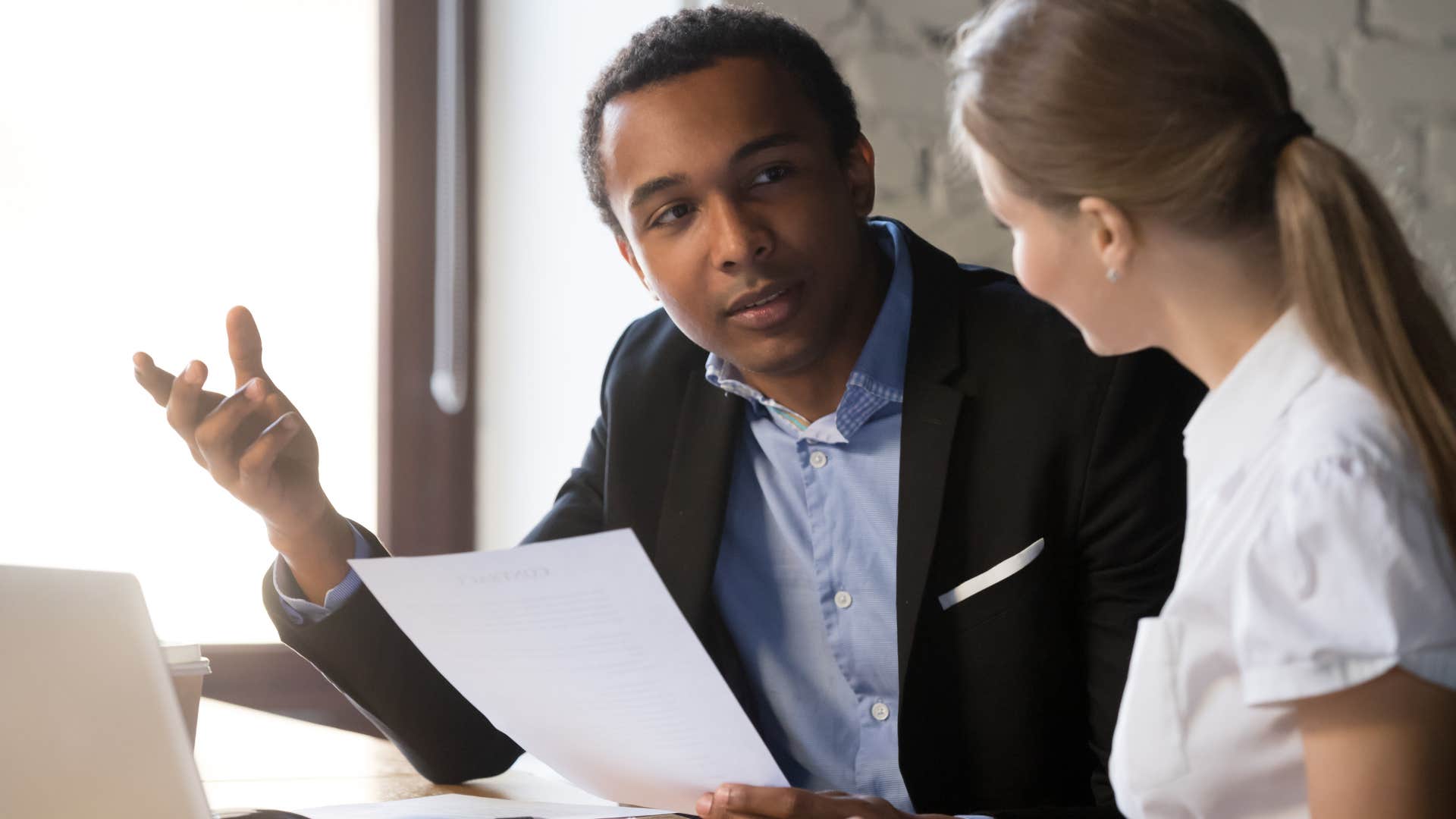 man telling his boss his plate his full at work