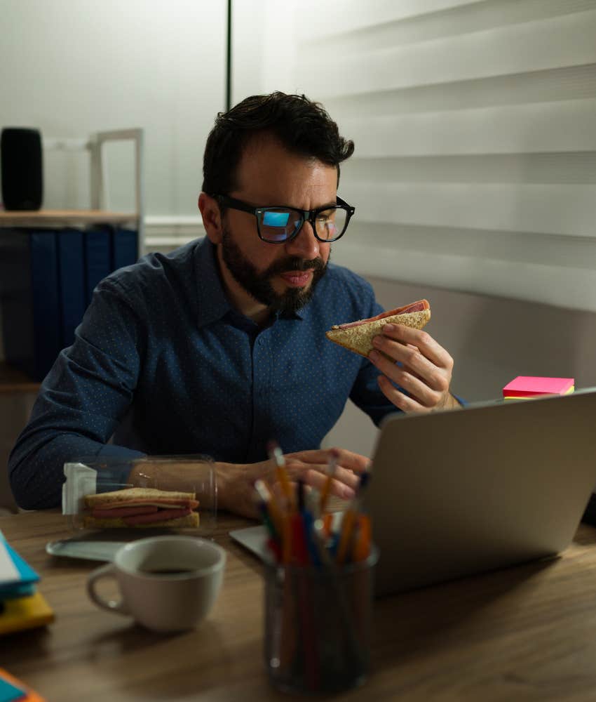 Tired person eats while working