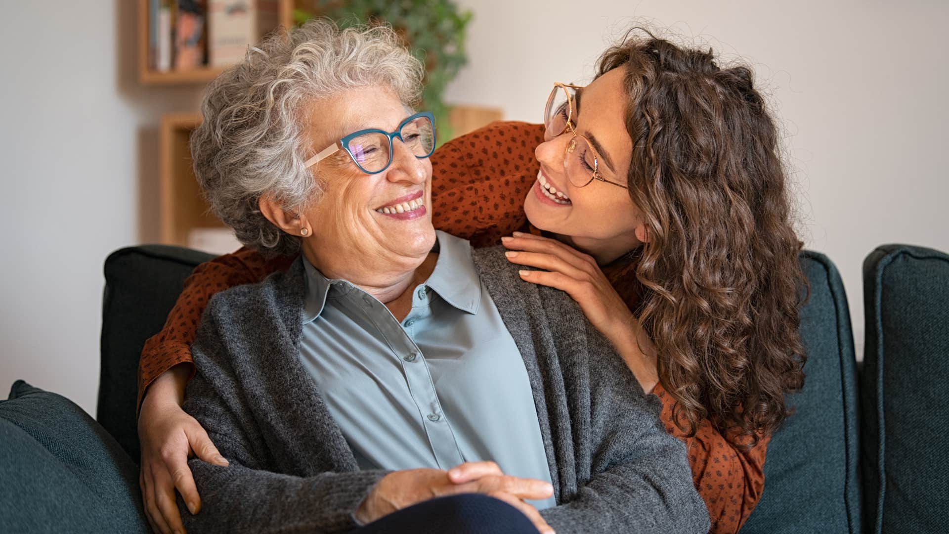 woman spending time with family hugging her grandmother