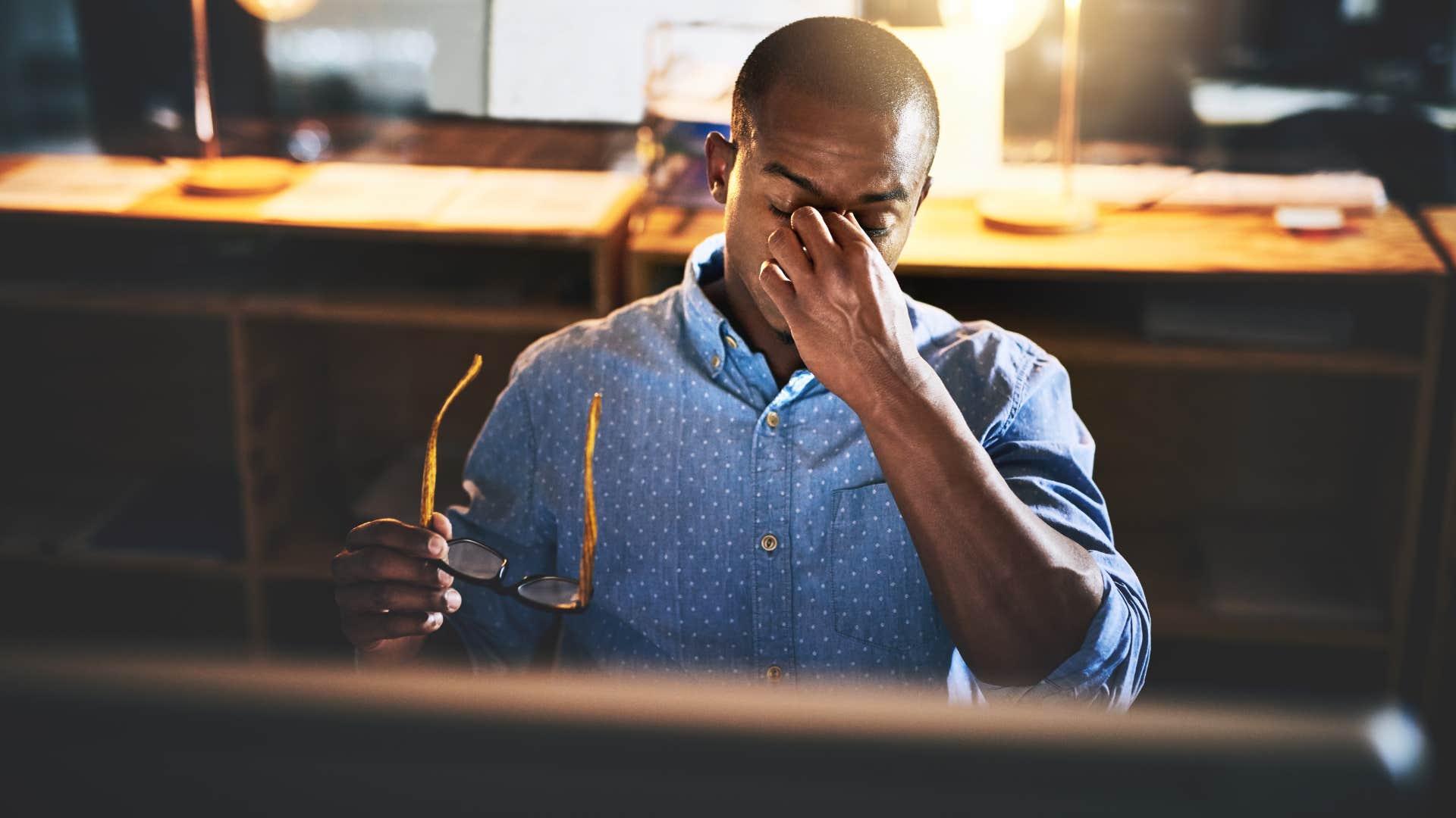 stressed man working overtime at office