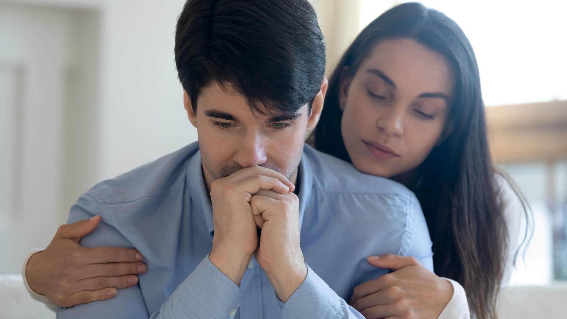 man being vulnerable with wife comforting him