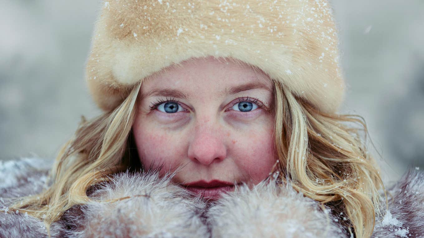 Cozy Habits That Keep Your Spirit Warm When The Weather Gets Cold Woman keeps cozy while weather gets cold.