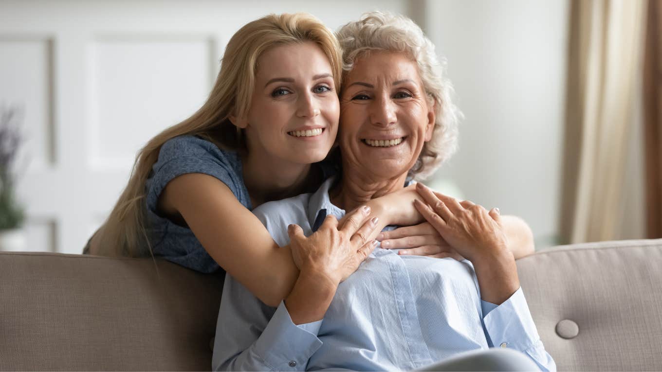 If You Don't Do These Things For Your Parents Now, You'll Seriously Regret It In 10 Years adult woman hugging her mother from behind smiling