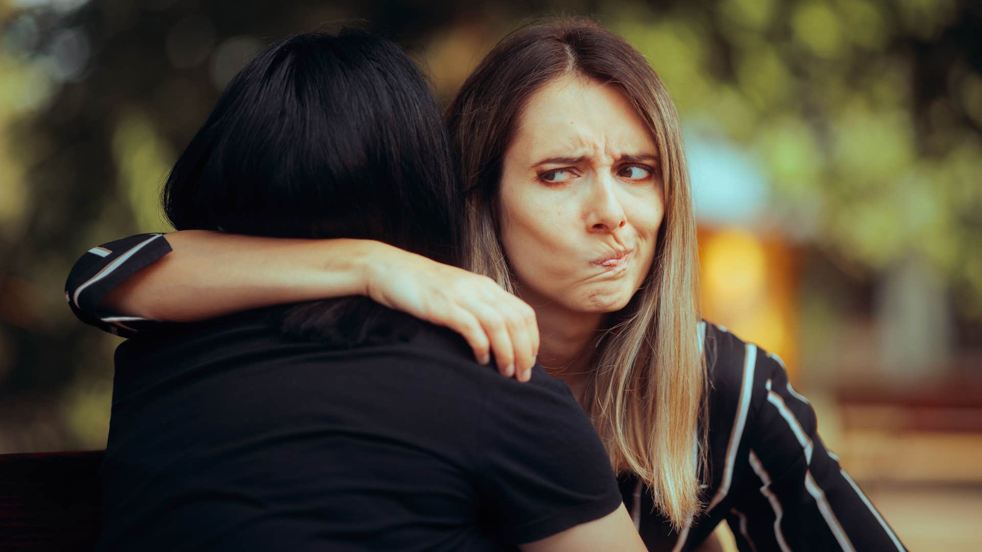 woman hugging other woman and thinking they are completely clueless