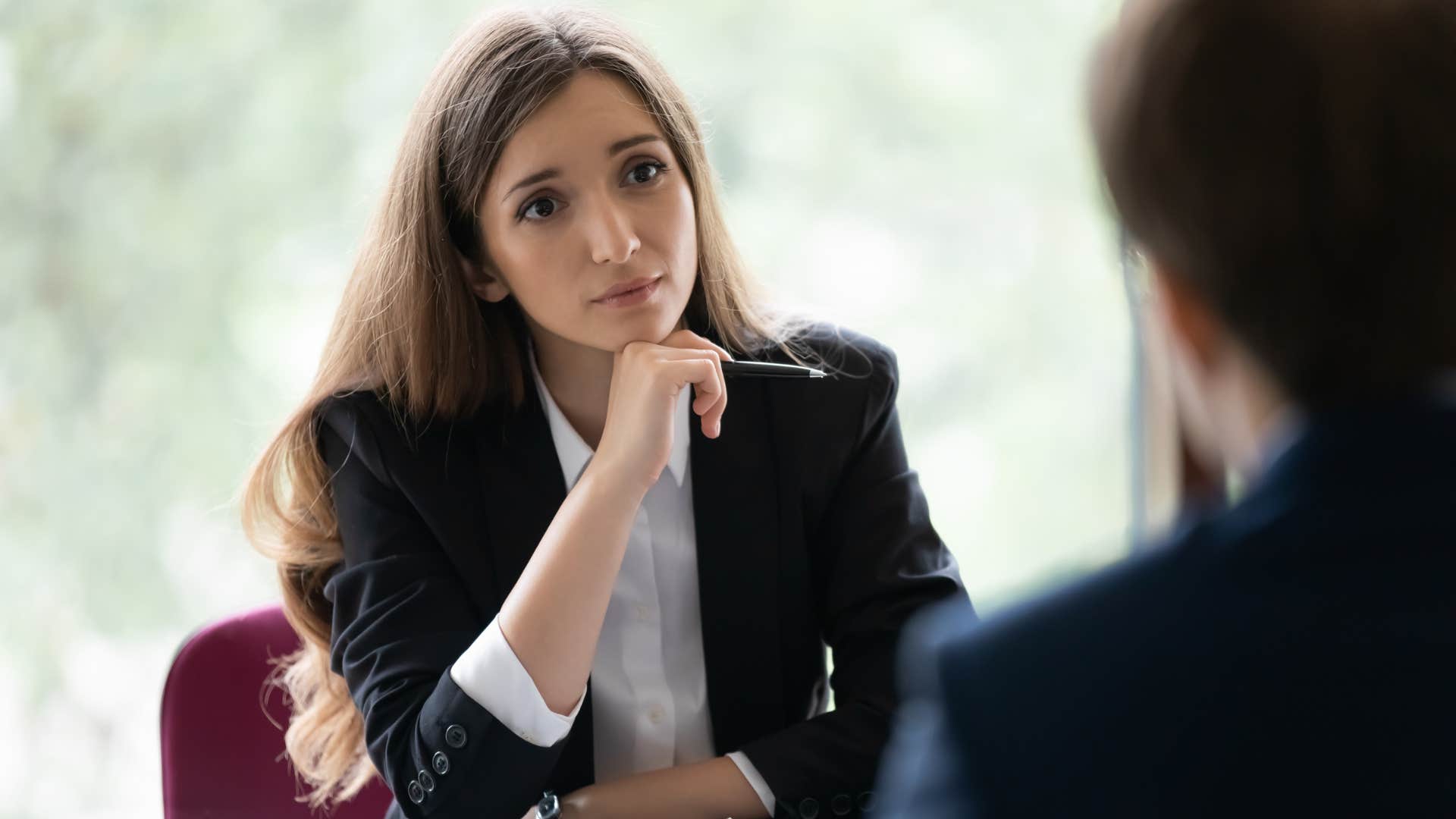 woman listening to work colleague talk