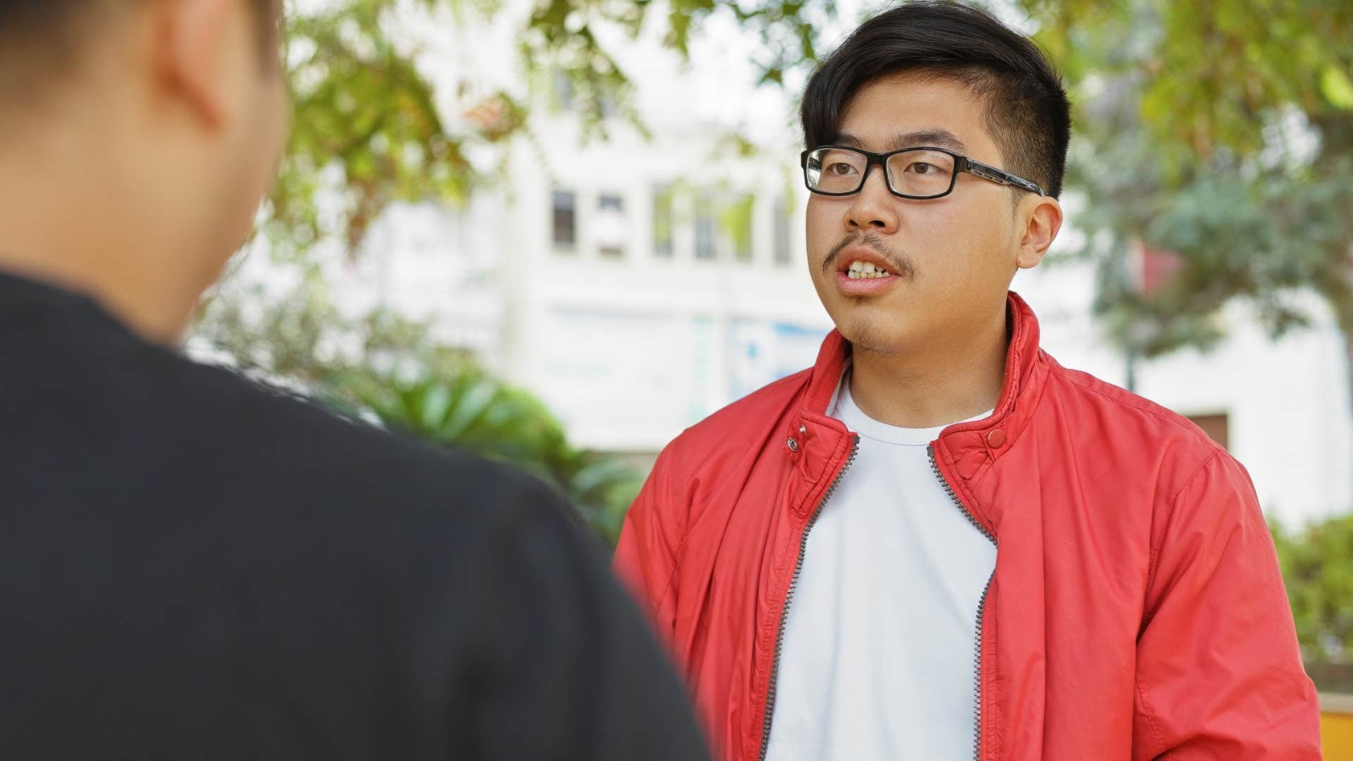 man talking with ignorant friend saying your logic is wonderfully resistant to reality