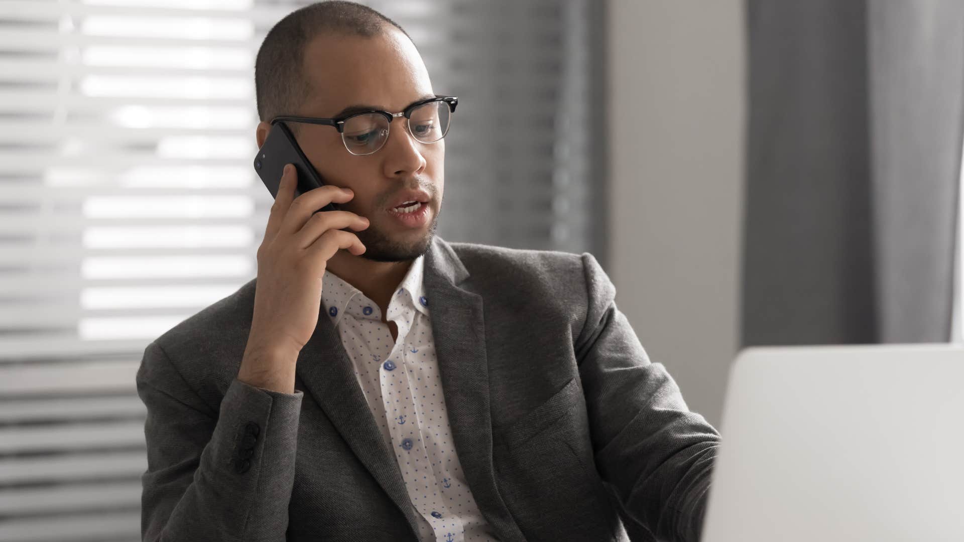 professional man on the phone saying I won't trouble you with matters of complexity