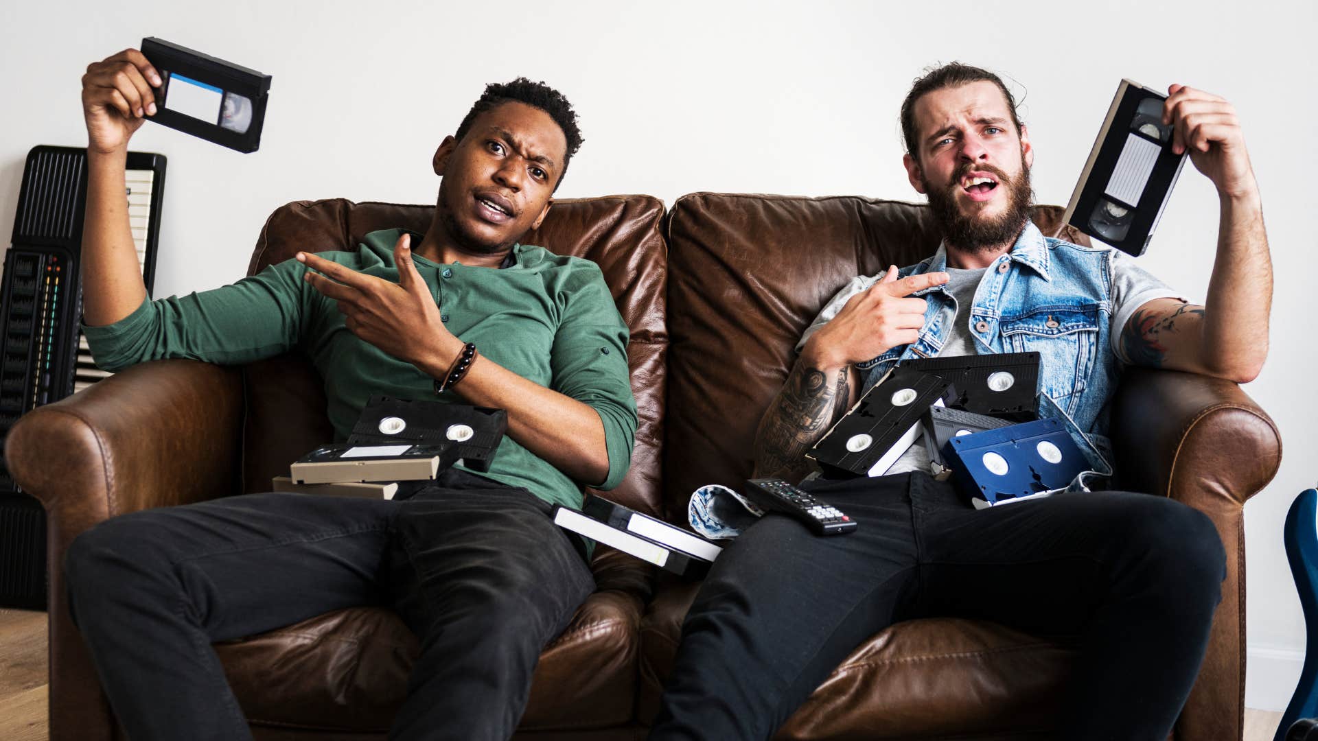 millennial men holding old vhs tapes from the 90s