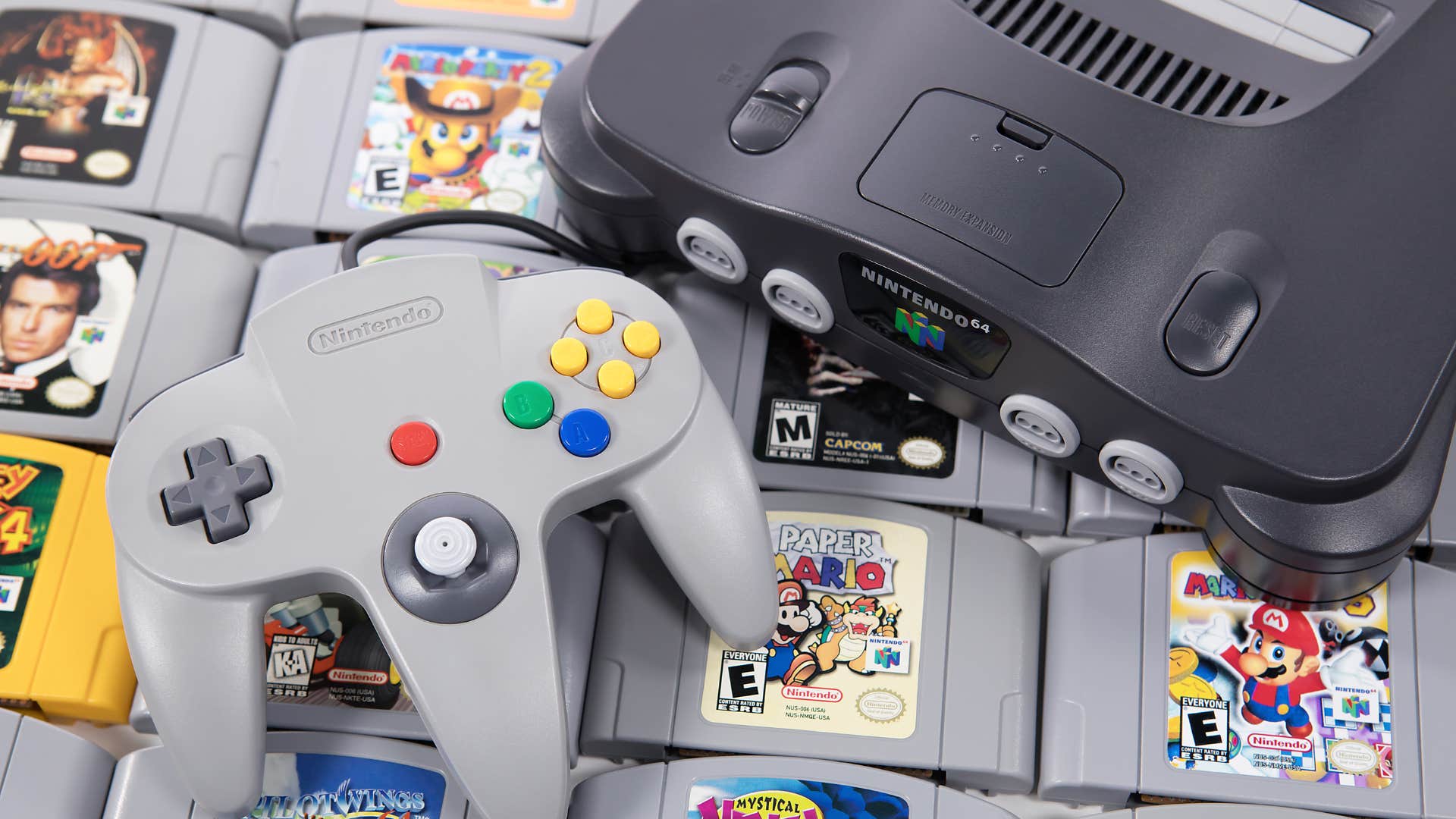 nintendo 64 console laying on top of various video games