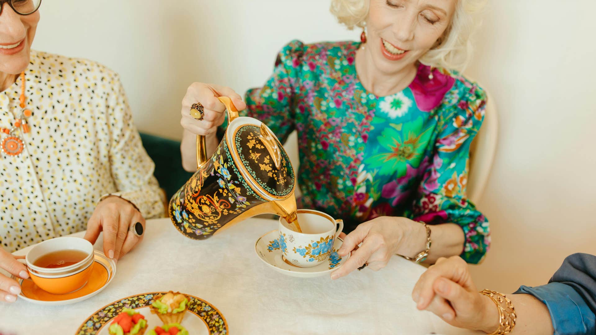 boomer woman using fine china with friends