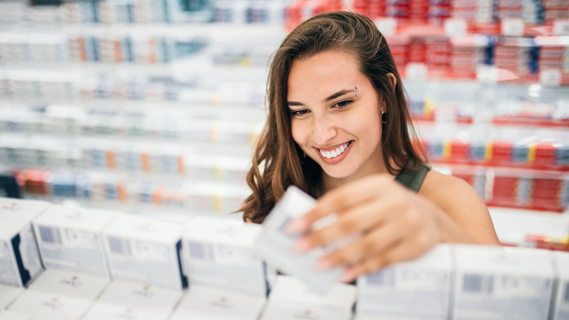 frugal woman buying drugstore makeup smiling