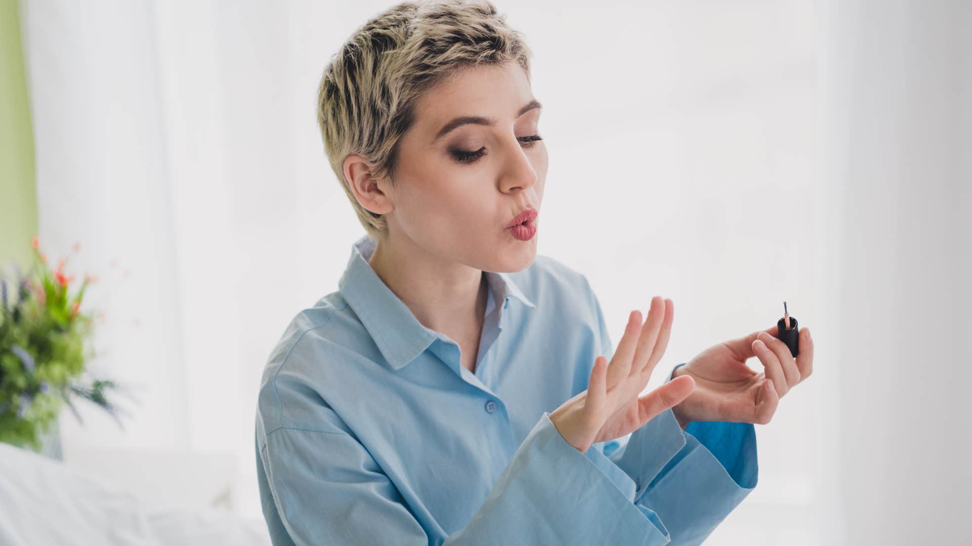 woman giving herself a manicure at home