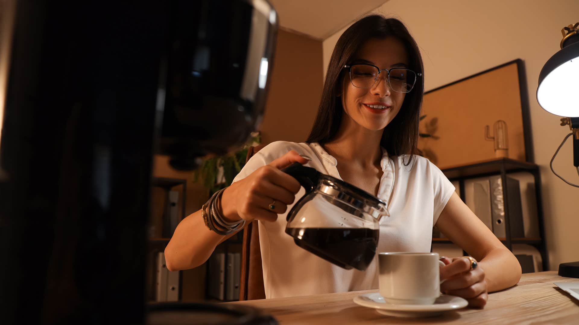 frugal woman making coffee at home in her kitchen
