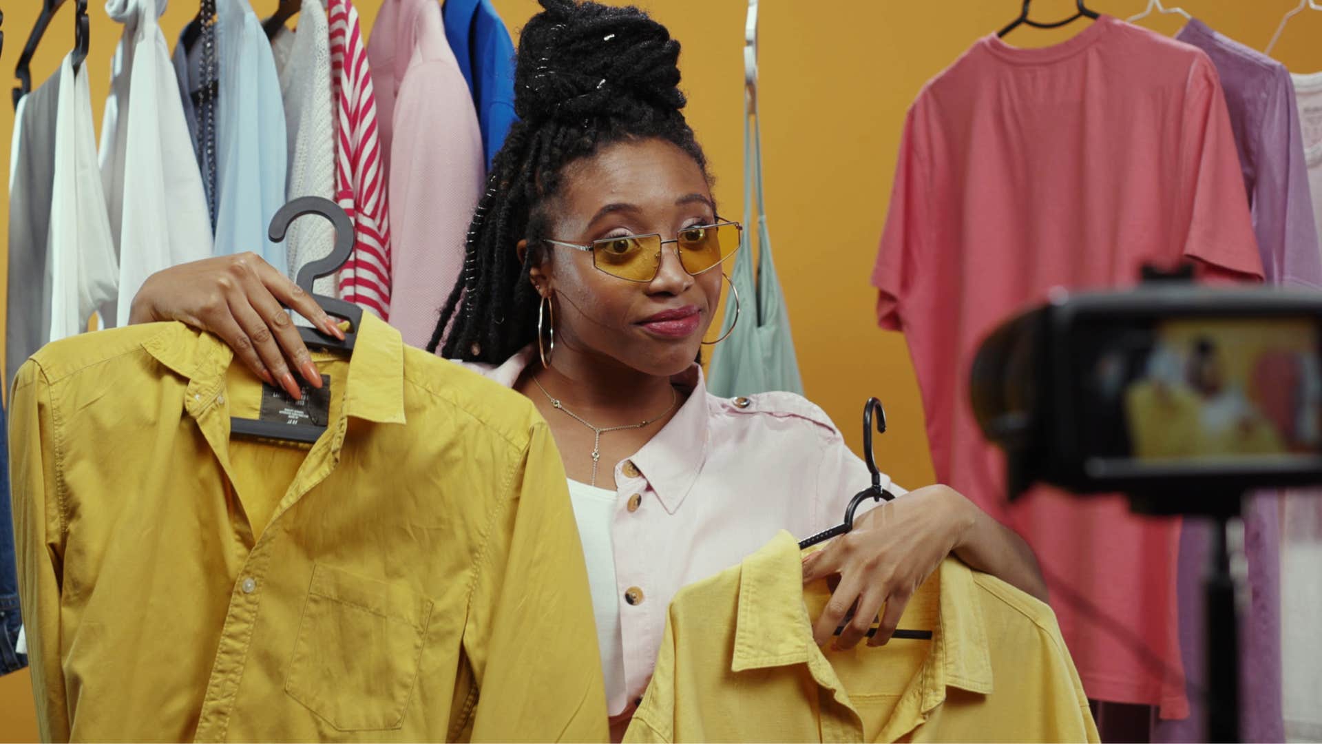 woman filming herself buying clothes