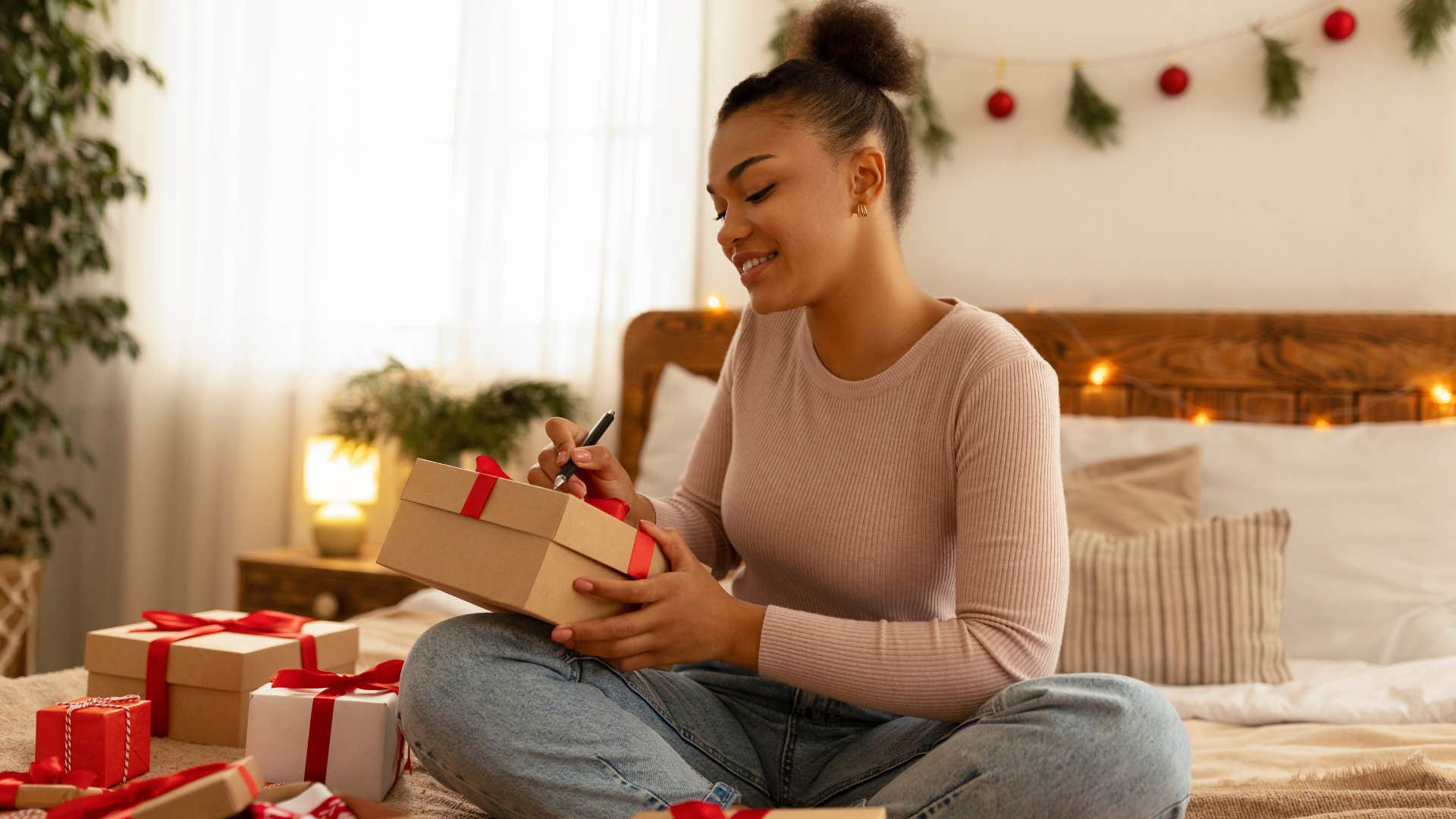 woman reusing gift wrap while holding presents