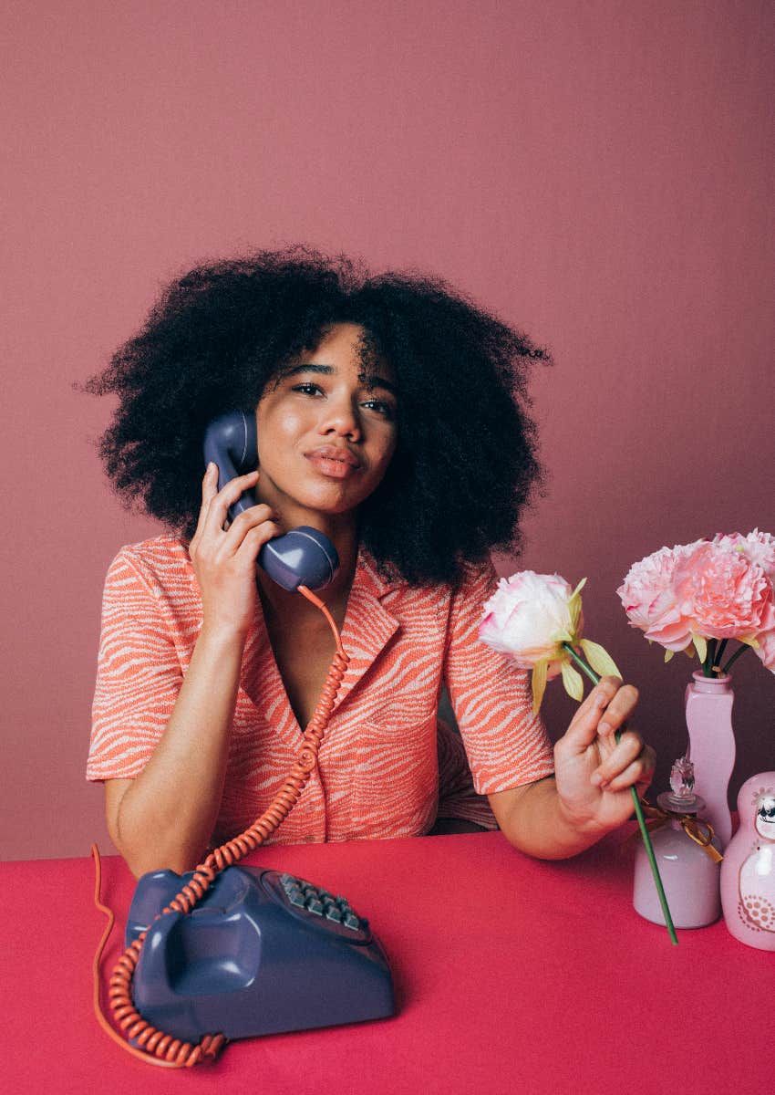 woman making a call on an old rotary phone
