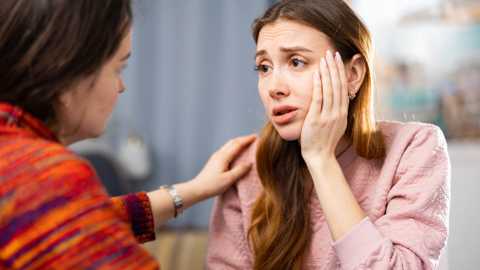 woman in crisis being comforted by concerned friend