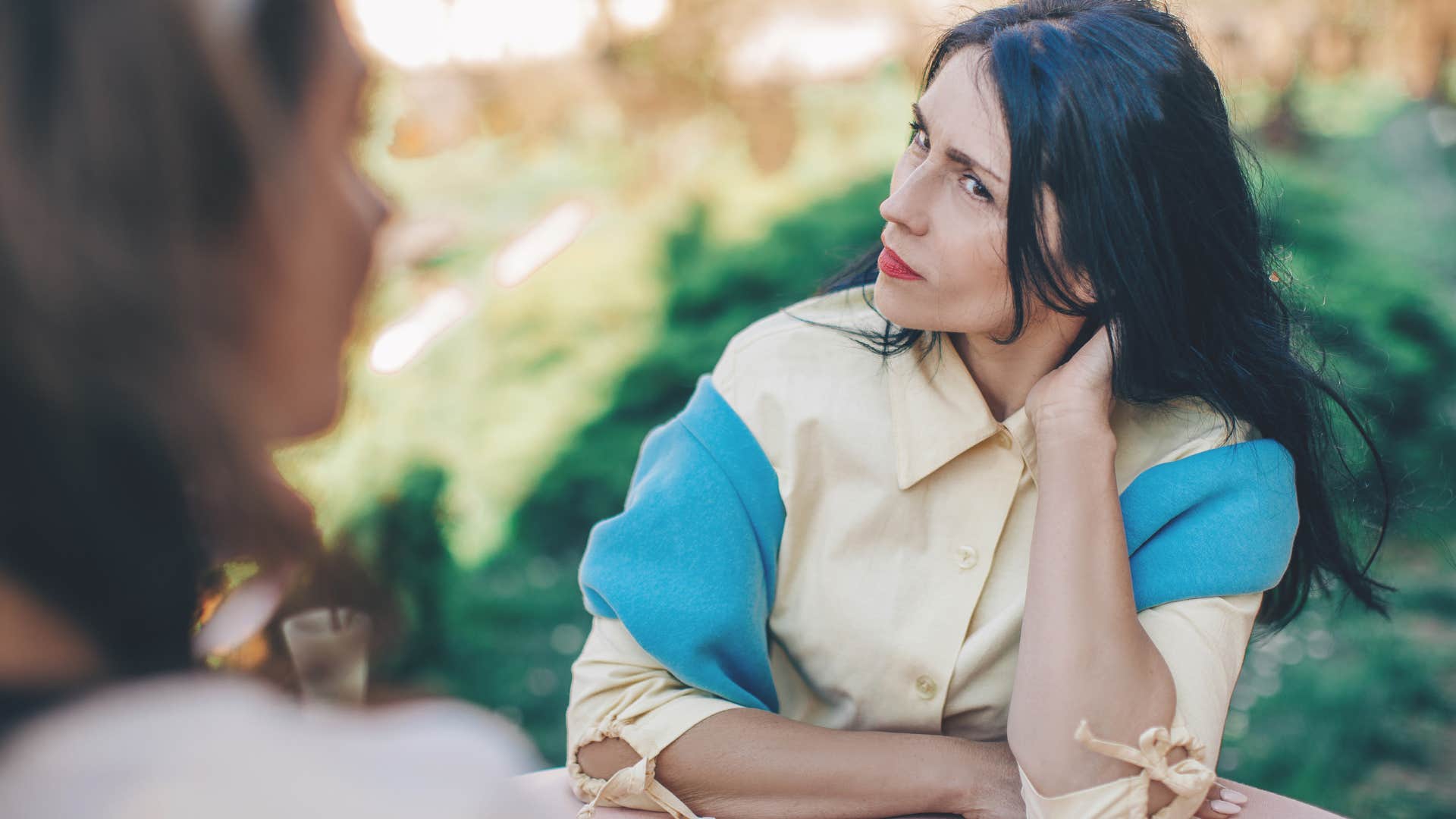 secretly competitive woman listening to friend talk