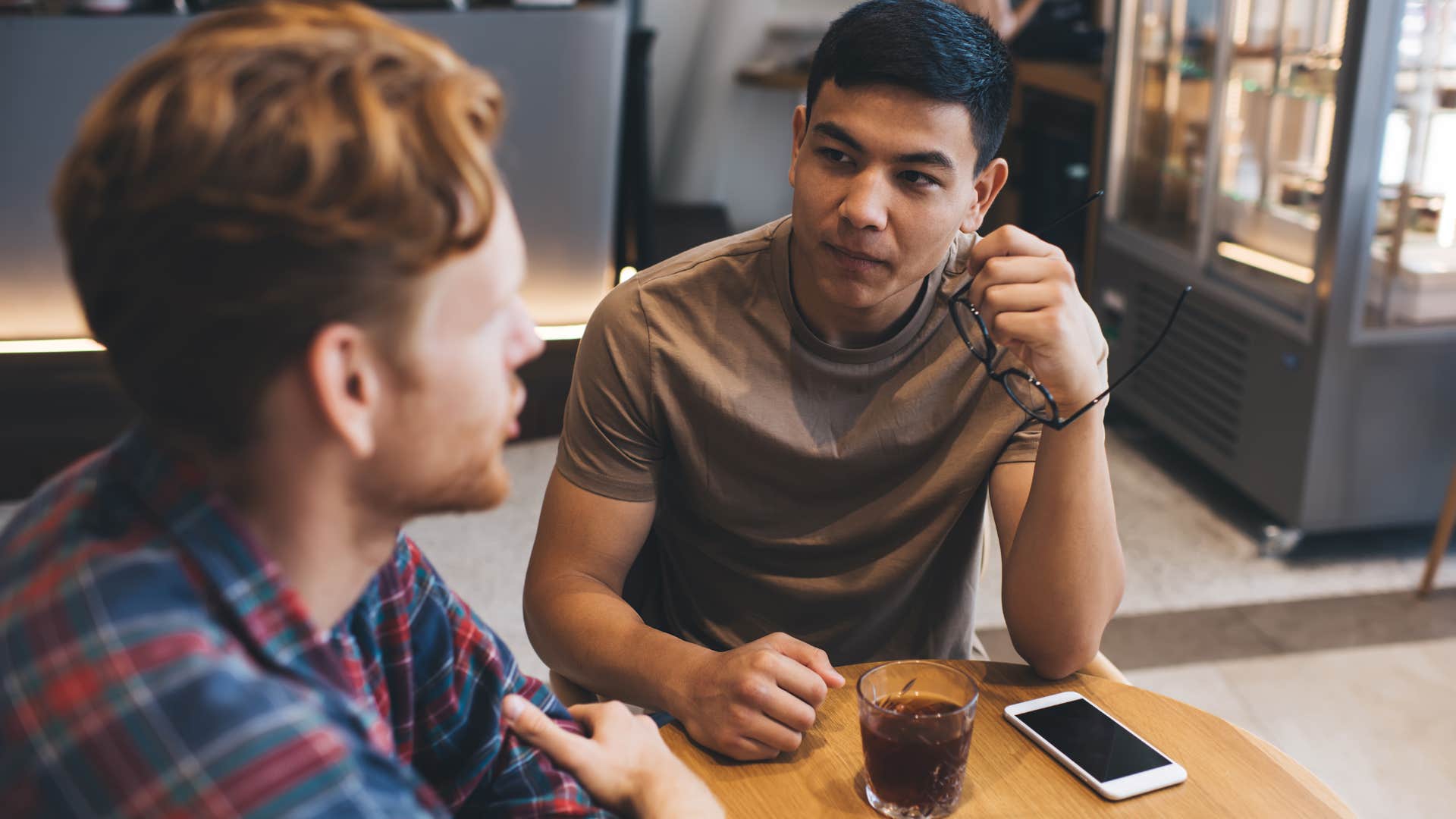 man talking to his friend trying to one-up him
