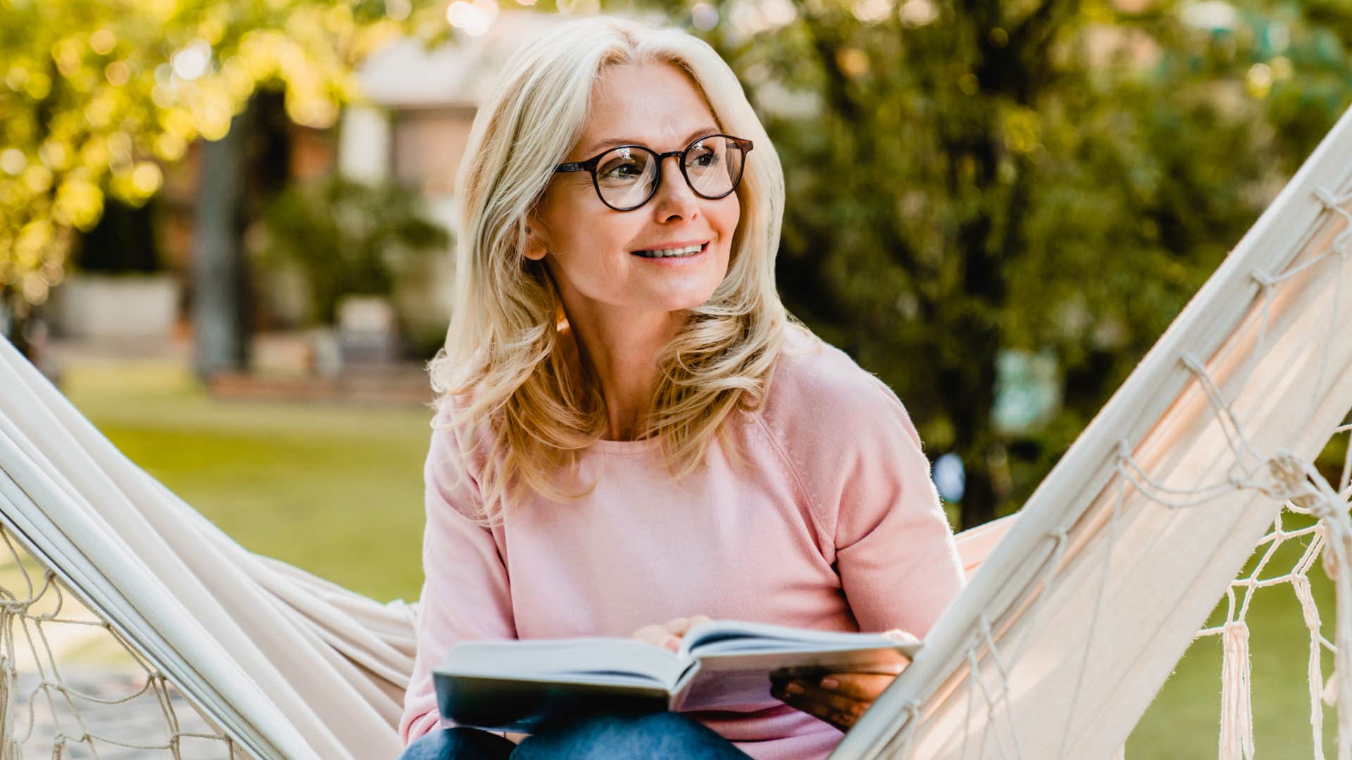 woman putting herself first reading in a hammock after divorce