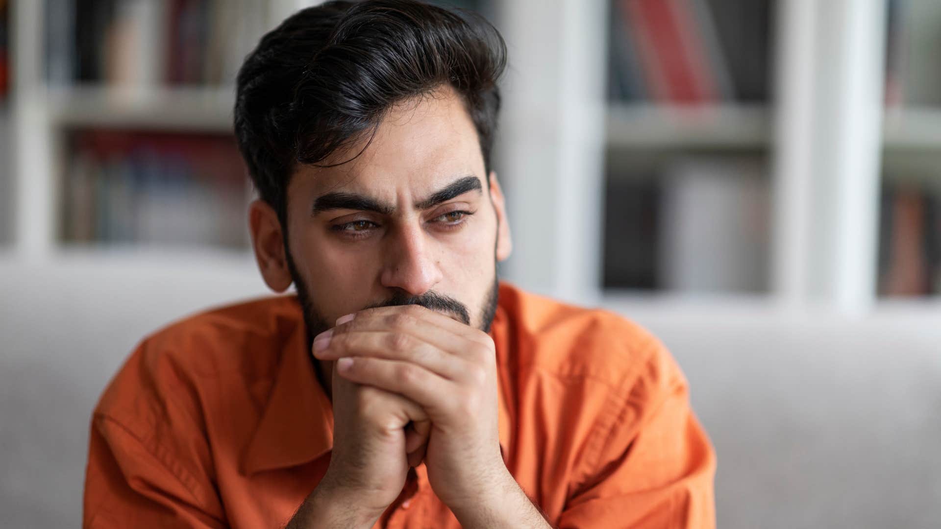sad recently divorced man sitting alone in quiet home