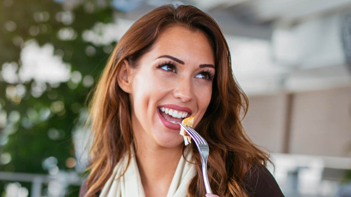 High-IQ Foods To Eat To Rewire Your Brain For Happiness Woman eats foods to rewire brain.