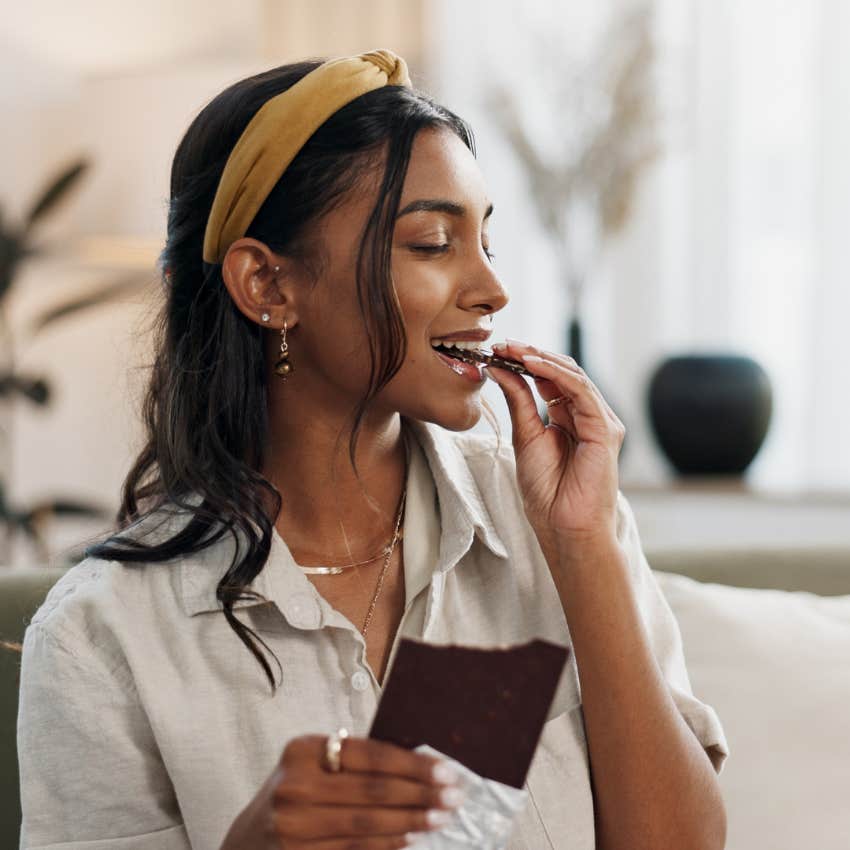 woman eating dark chocolate that is a high-iq food