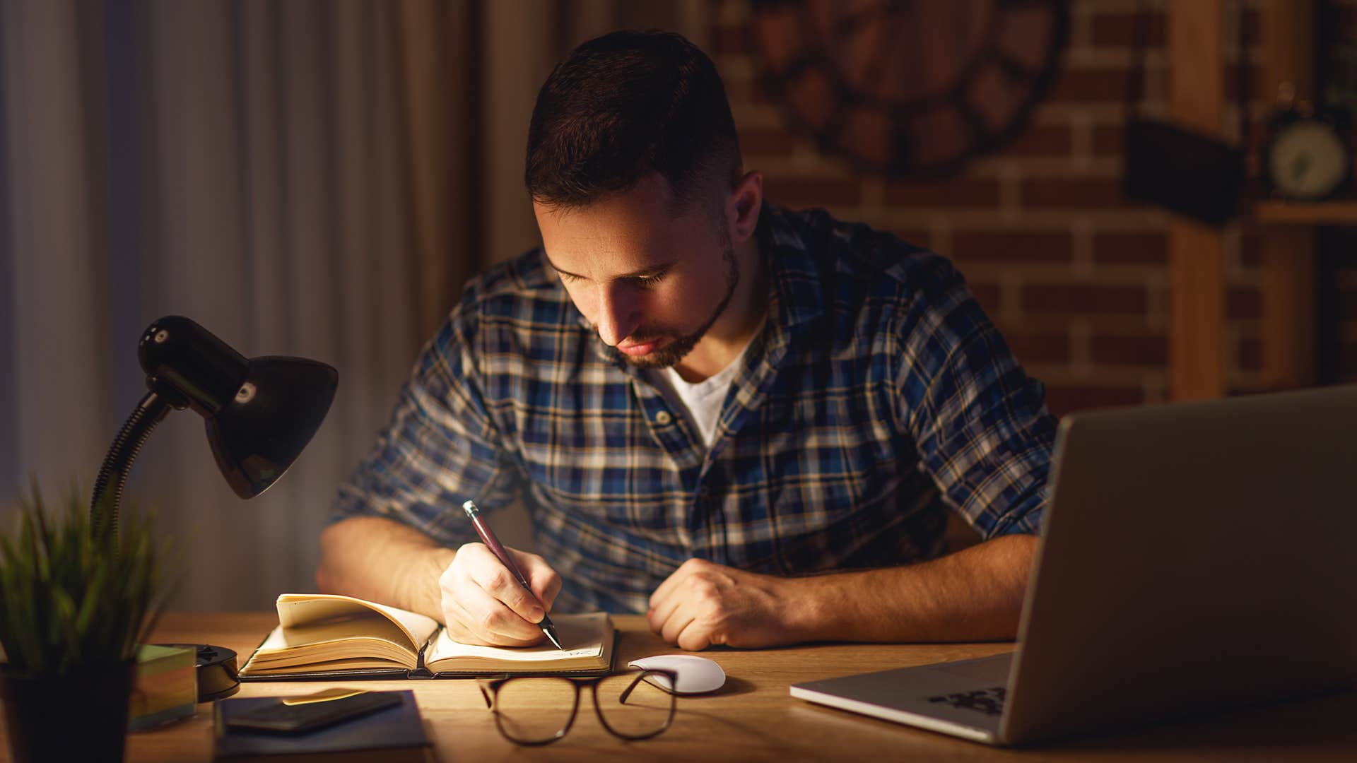 man choosing work over home life working late at night
