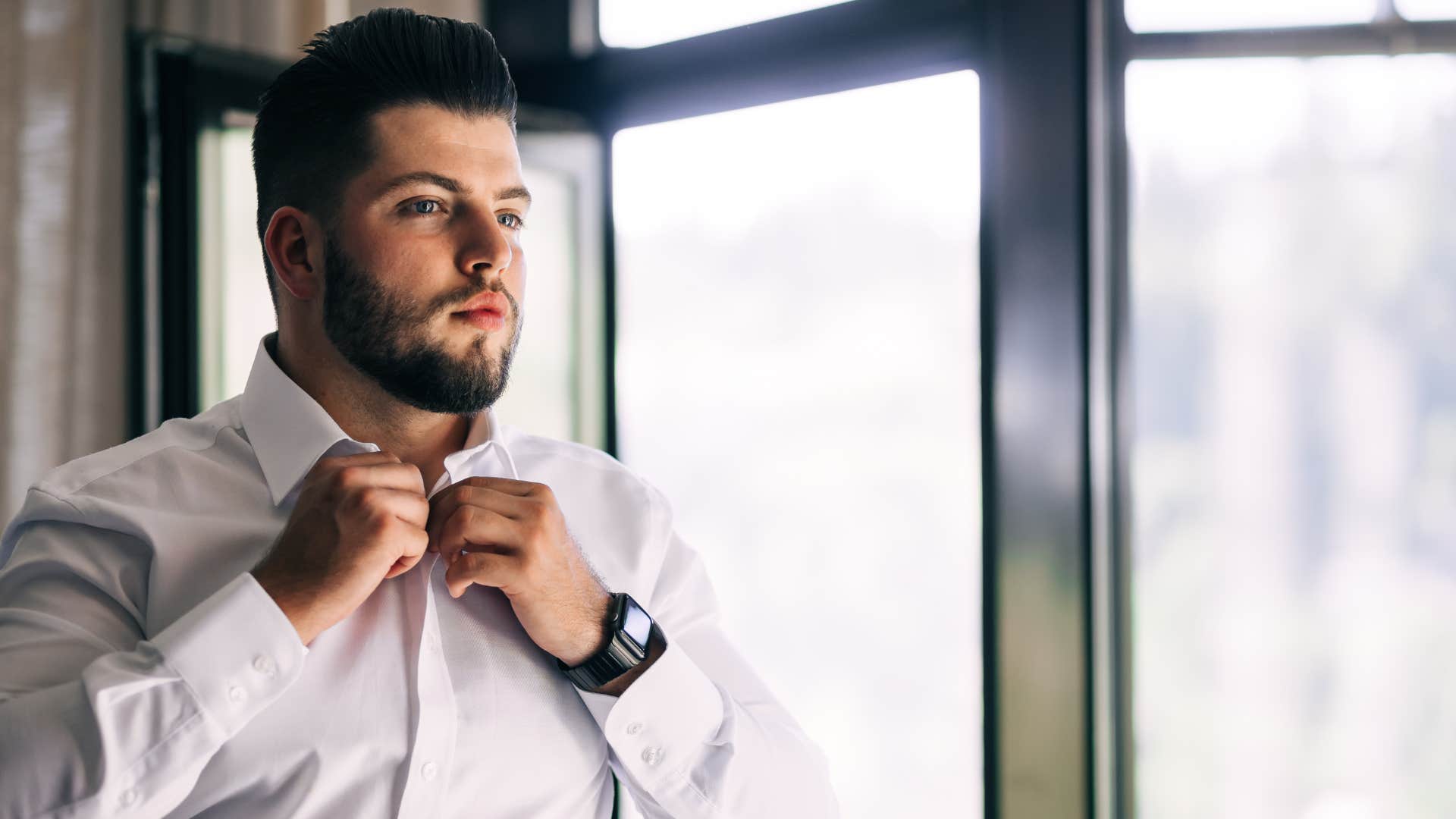 man obsessing over his appearance fixing his collar