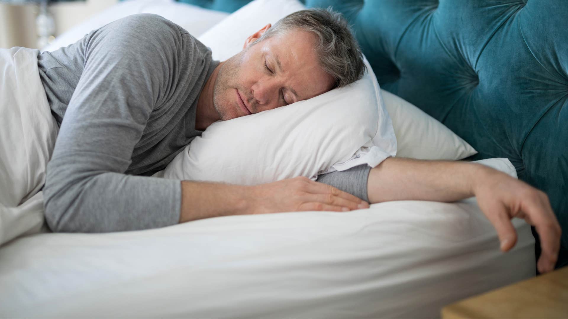 man sleeping too much in bed