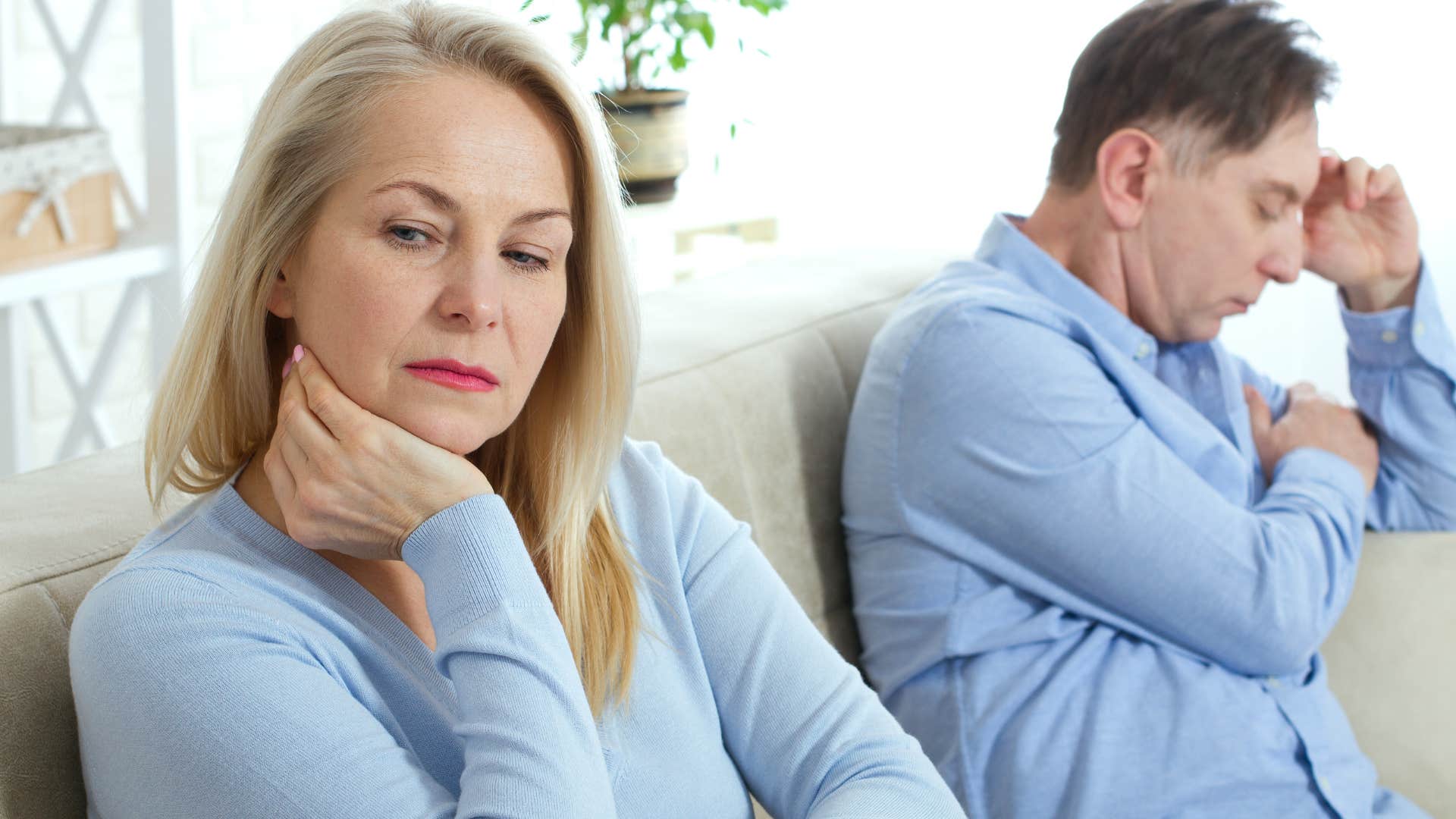 Woman turned away from a man who fails to acknowledge her needs.