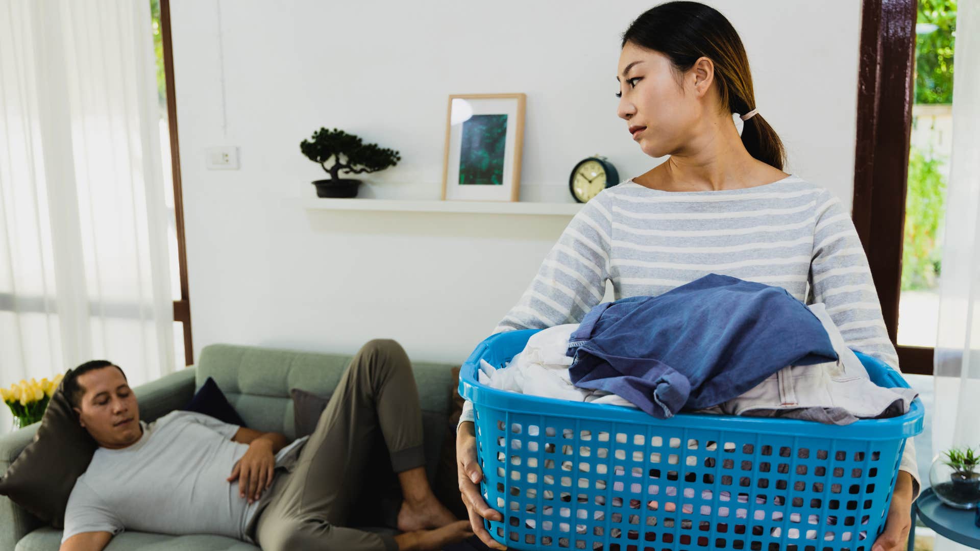 Woman glaring at her husband who never helps at home.