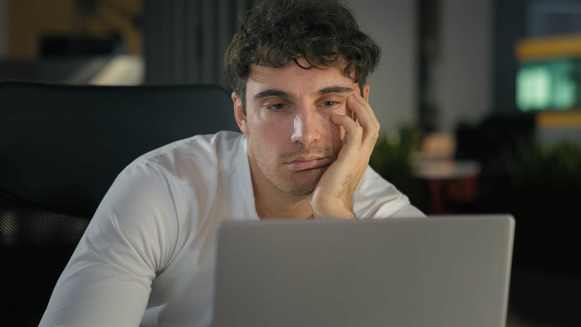 Man who prioritizes work looking at his laptop.