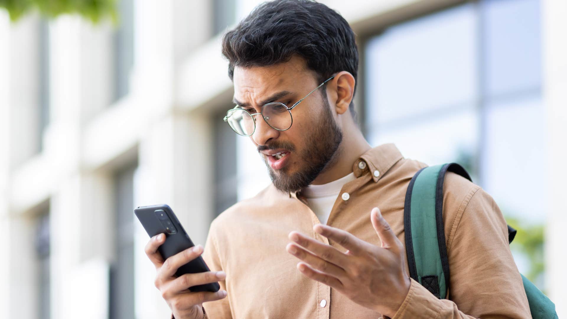 Upset man saying "if they don't agree with me, they're wrong" to his phone.