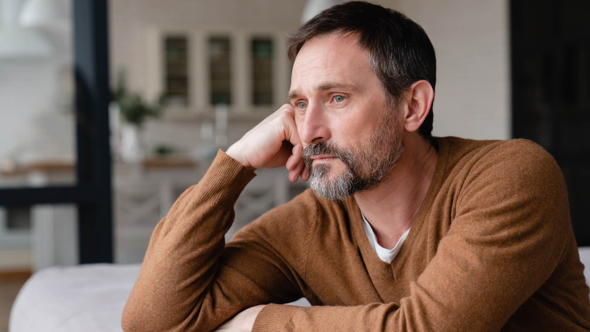 man thinking about his family thinking they burned bridges with him