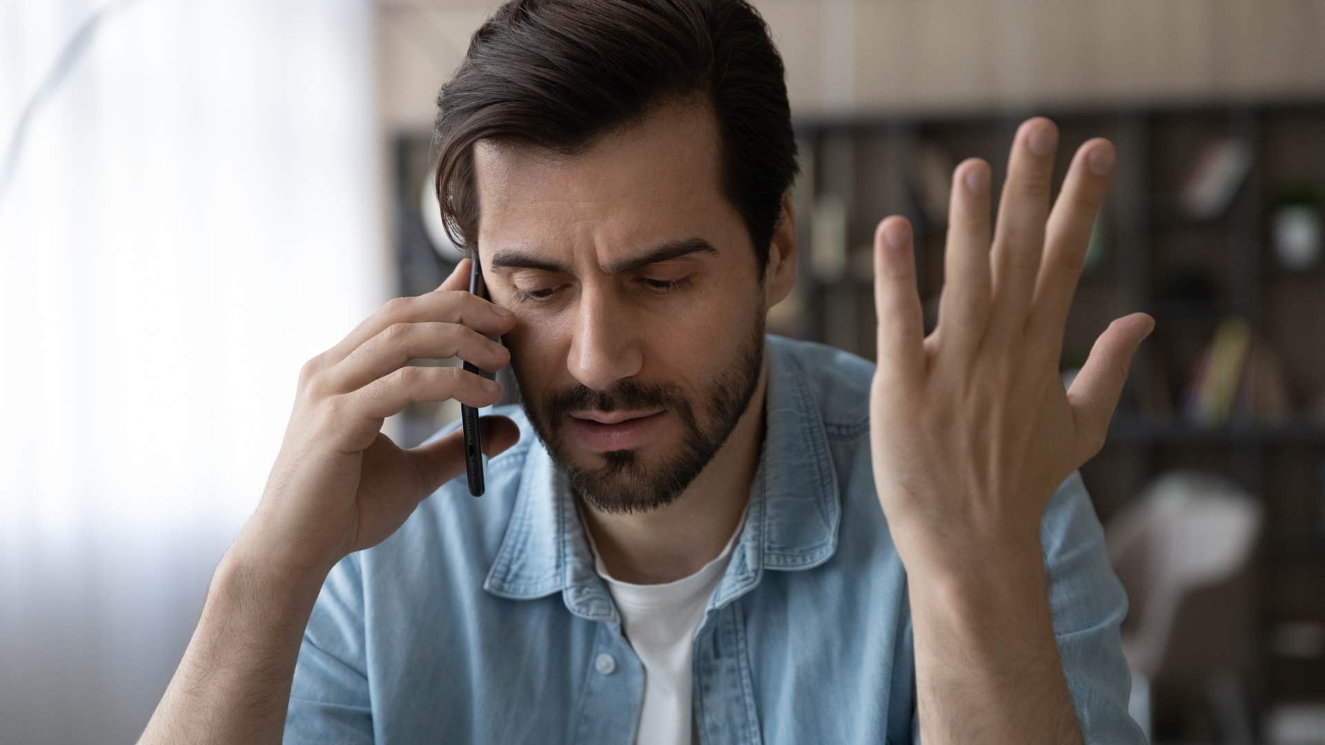 upset man on the phone saying I don't care what they think anymore about his family