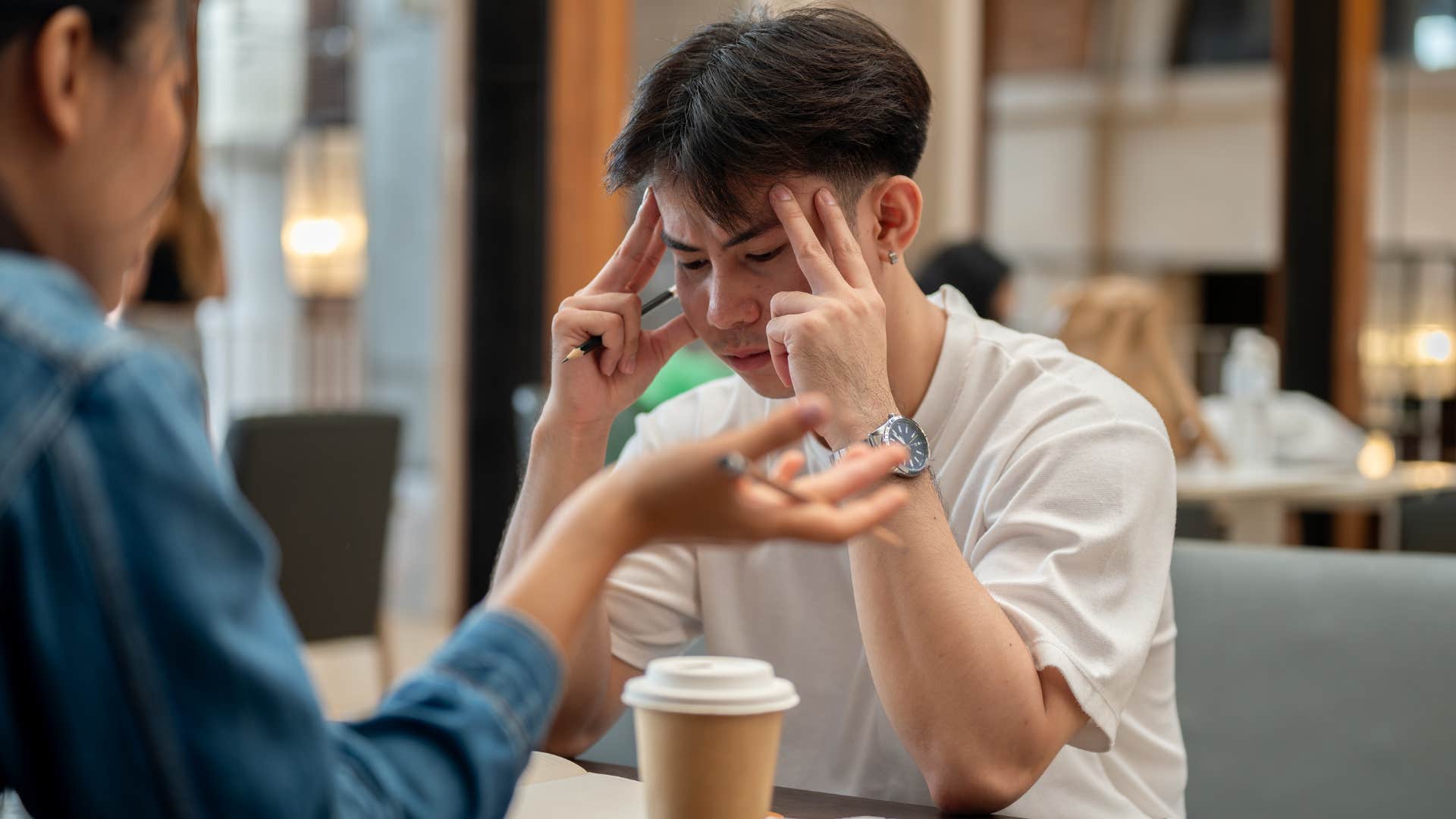 young man upset that his parents treat him like a child