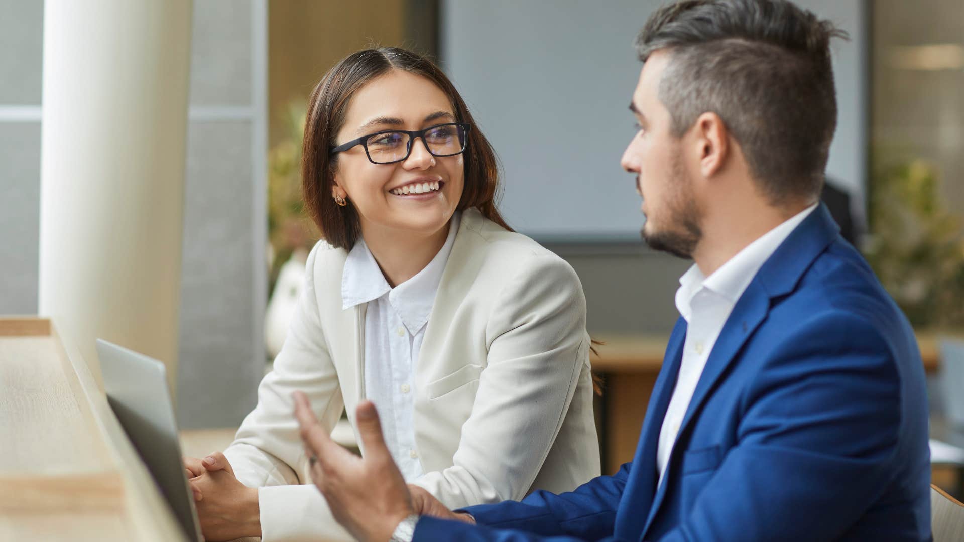 good man asking female co-worker what she thinks