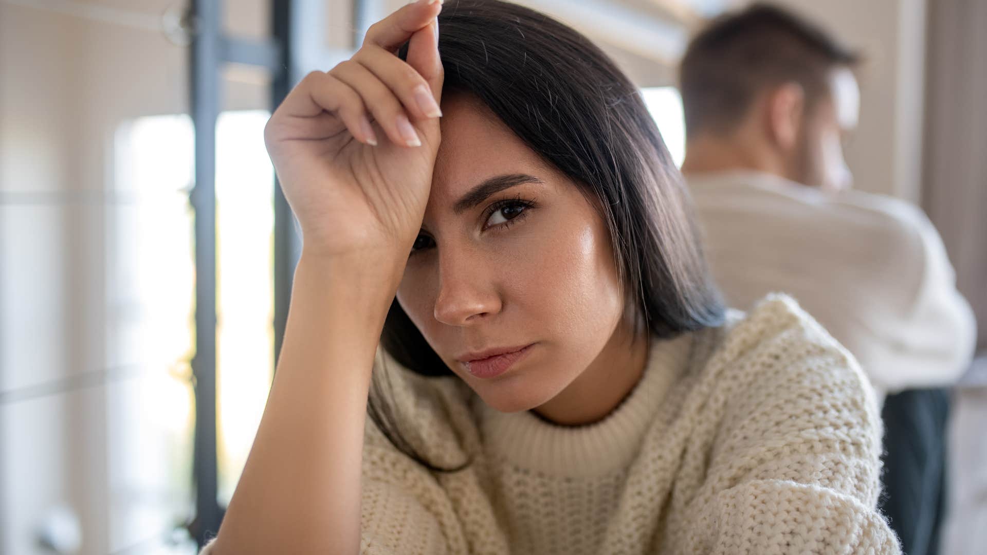 annoyed woman looking stressed turned away from husband