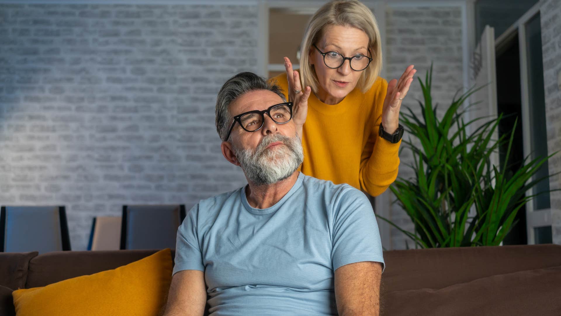 irritated woman telling husband it must be nice to do nothing all day