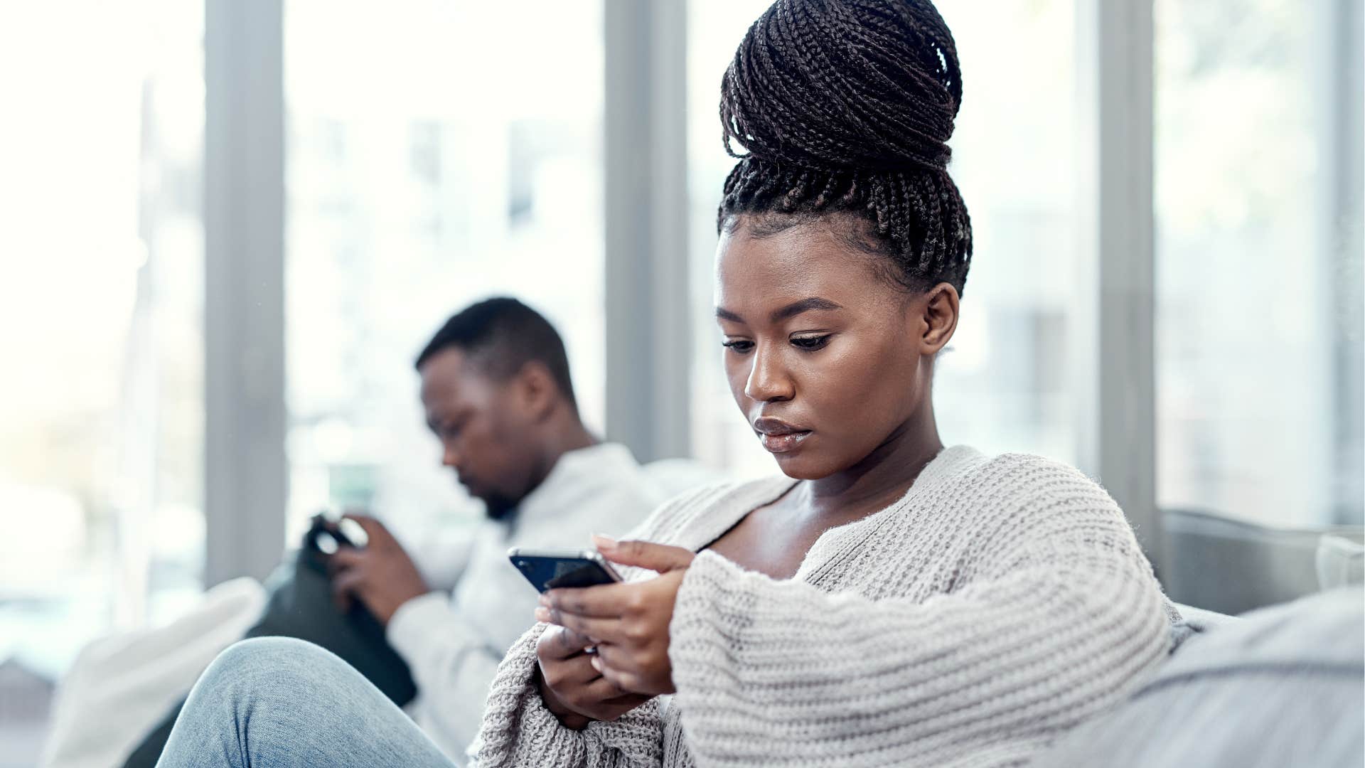 stressed woman saying it's been busy at the office turned away from her husband