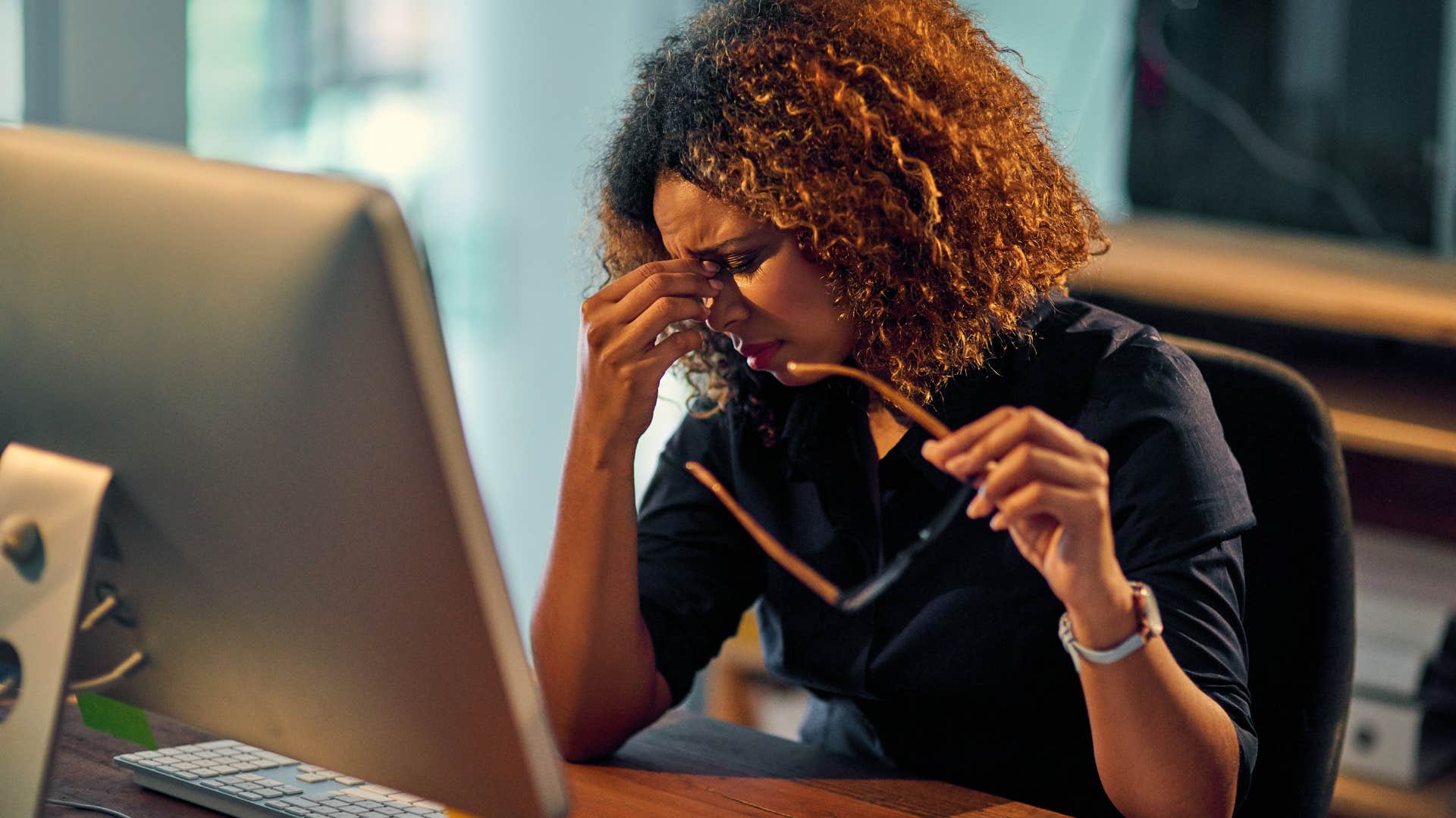 tired woman doing overtime at work