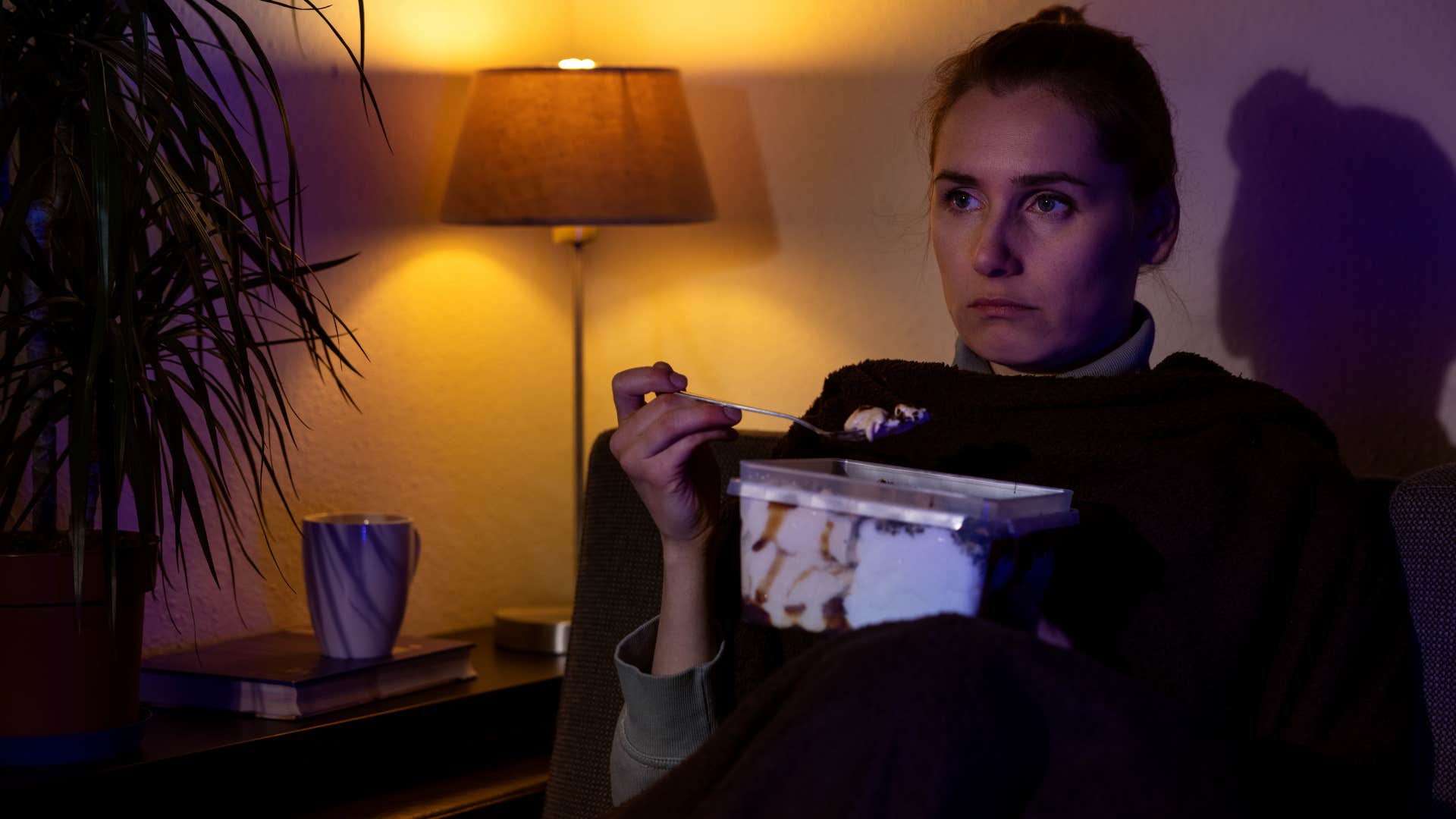 unhappy woman staying up later than normal on her couch