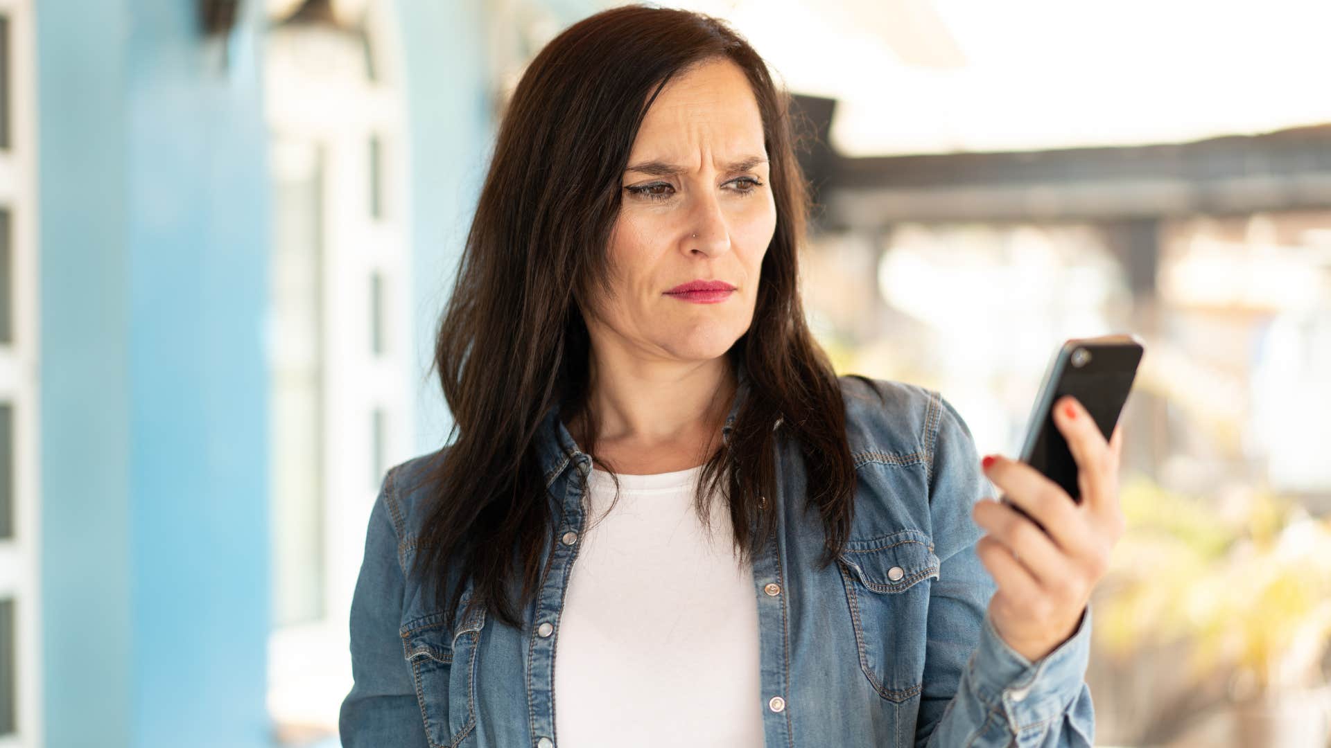 woman staring at phone saying that's not my problem