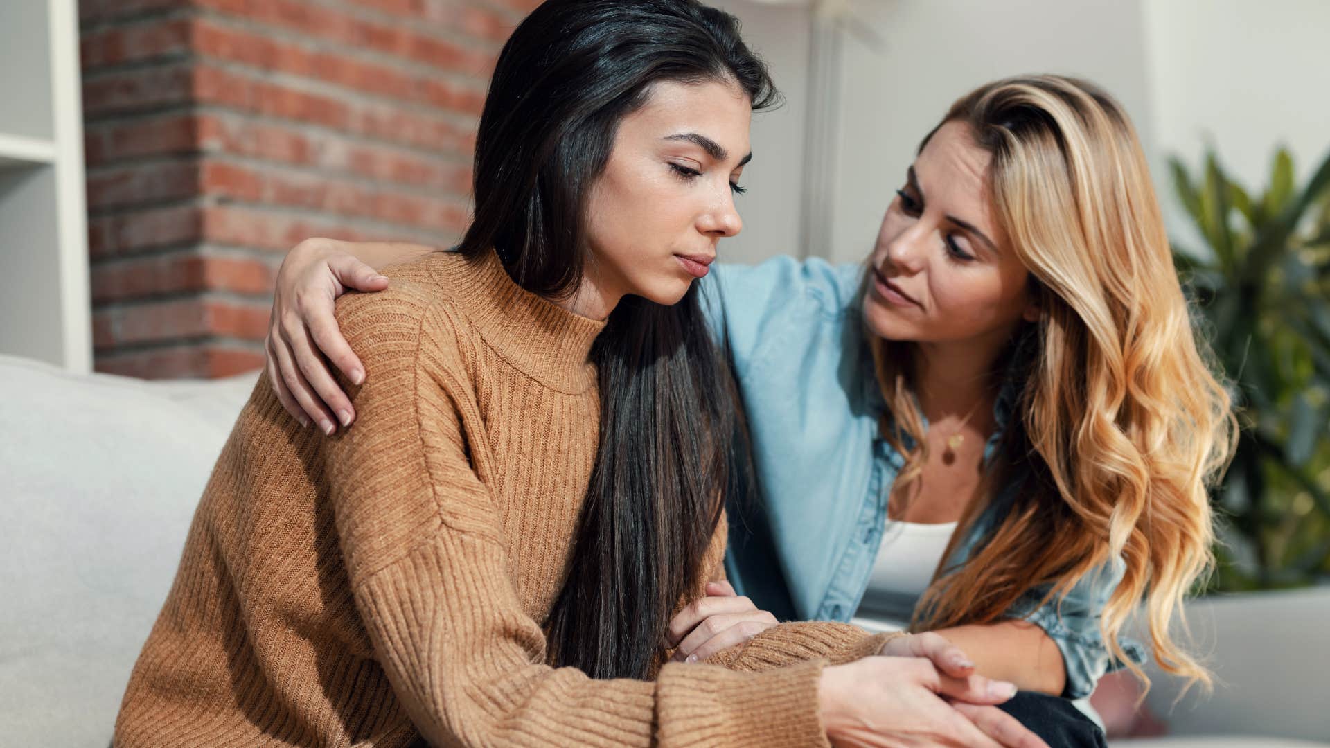 woman comforting friend asking to help her understand