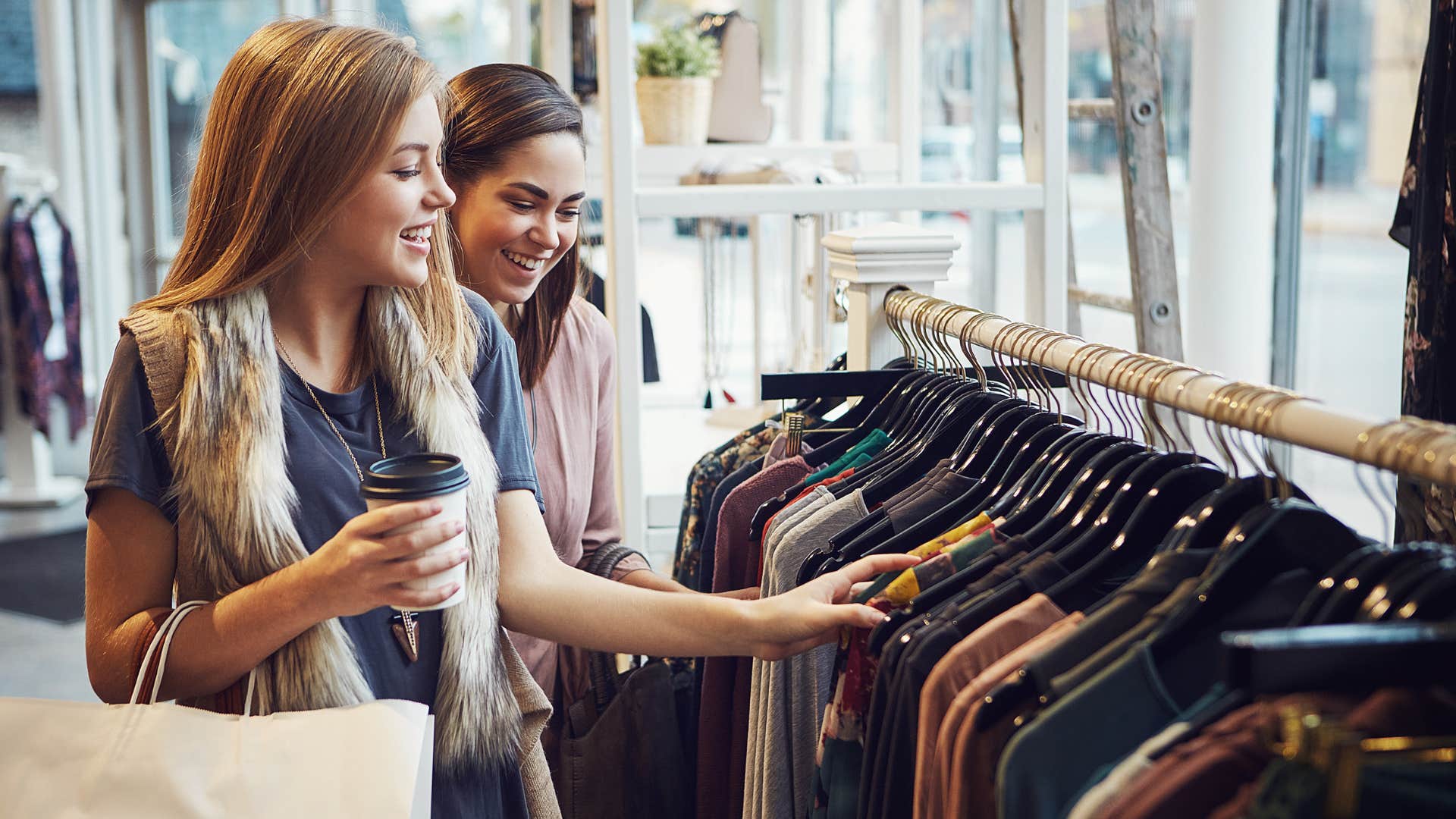 millennial women shopping for designer clothes