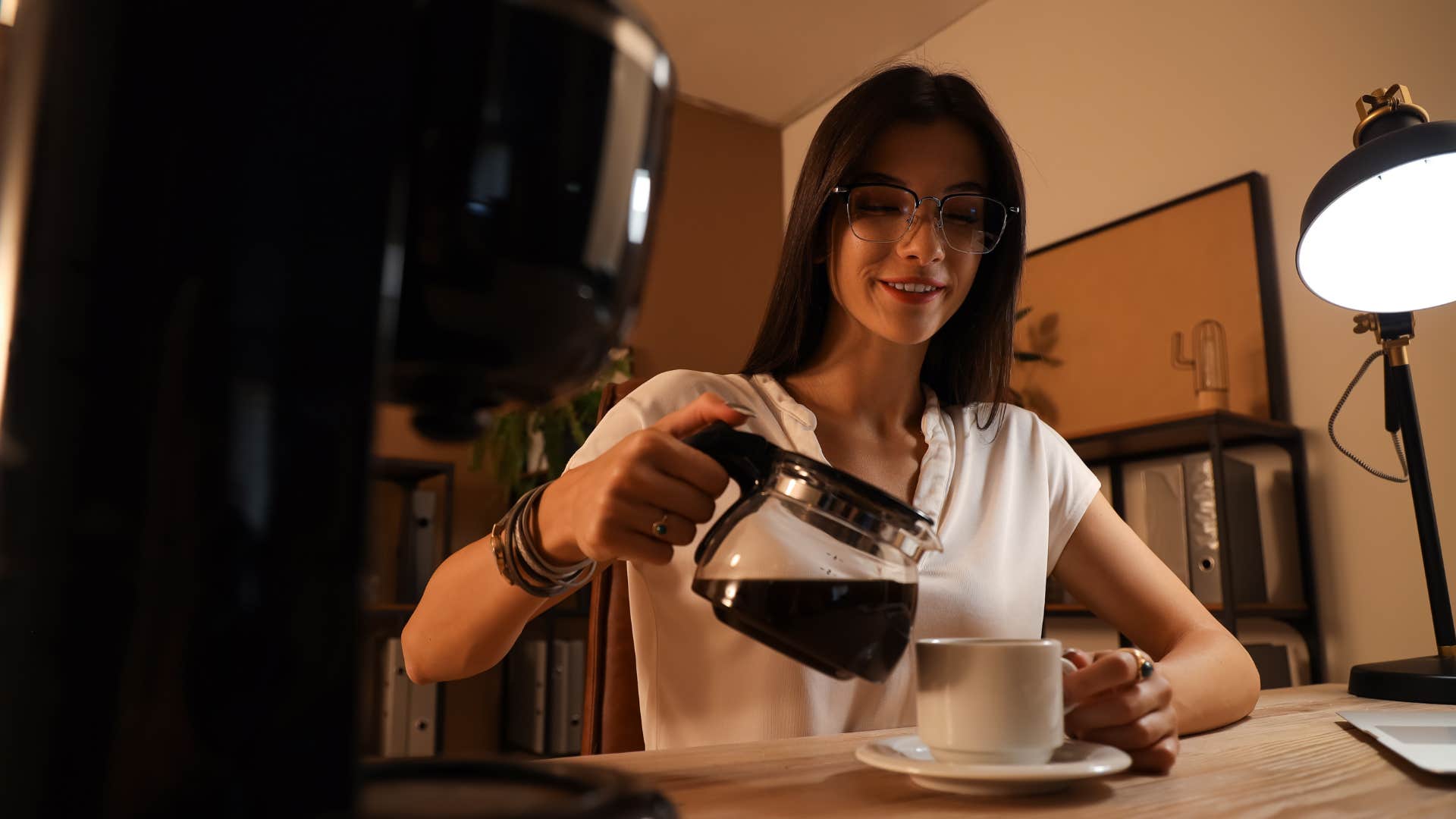 millennial woman brewing coffee with fancy machine