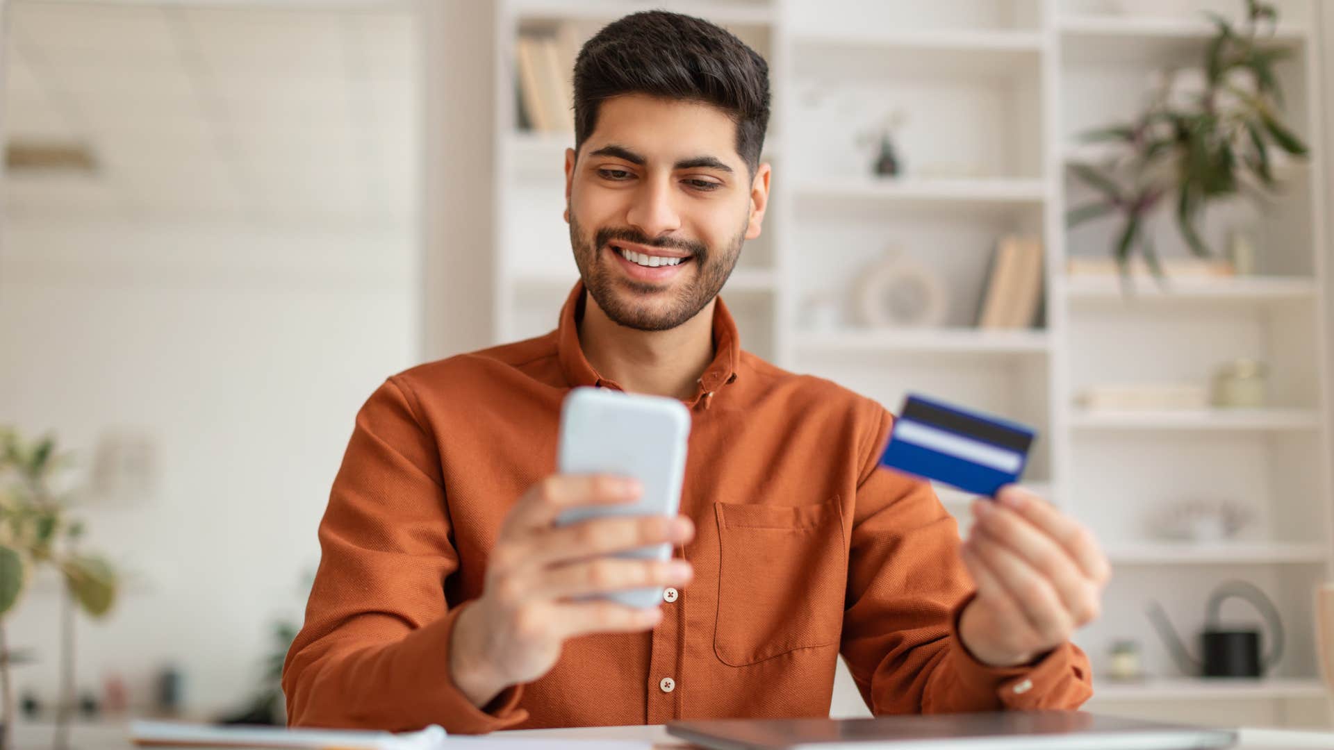 millennial man buying premium subscriptions with his credit card