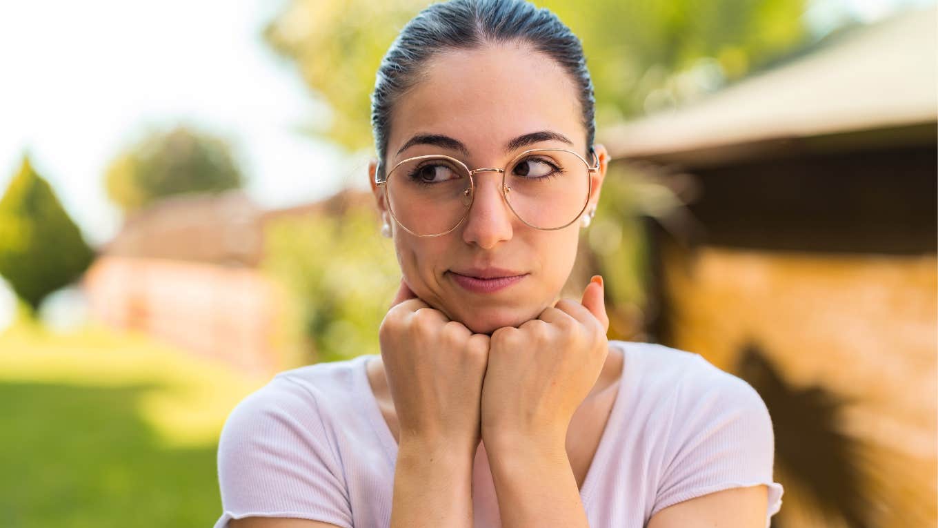 millennial woman pretending to be rich looking suspicious